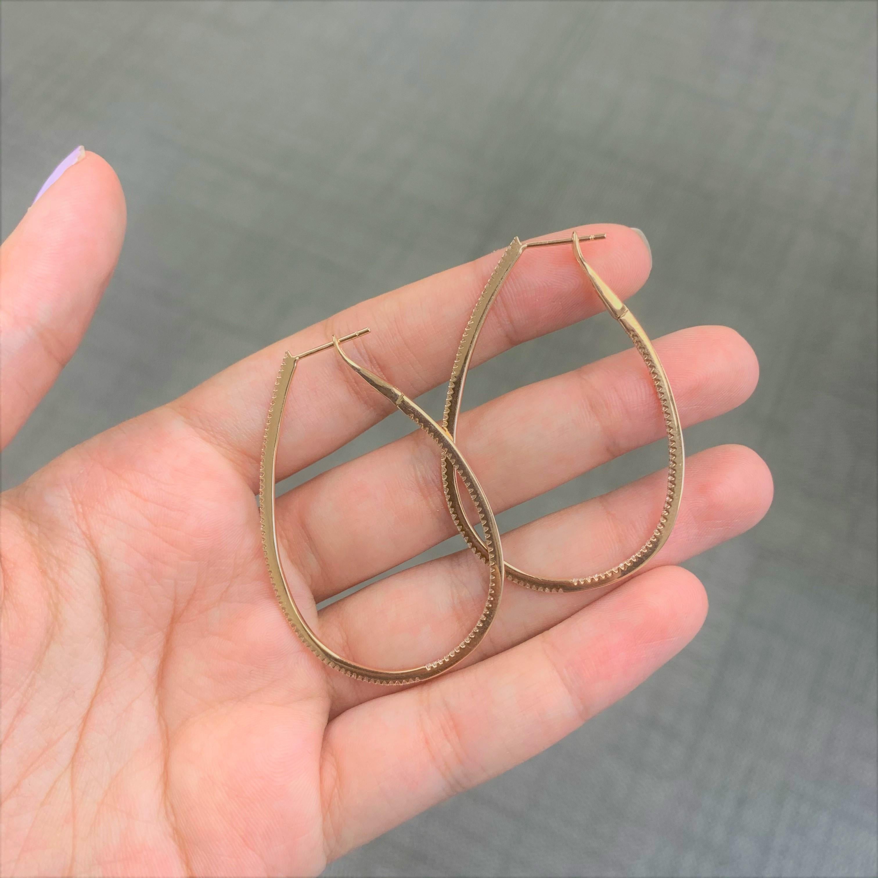 Set your lobes aglow in the classic shimmer and shine of these luxurious pear shape skinny hoop earrings! A dazzling array of diamonds fire up and down the design crafted from 14k white, rose or yellow gold. Lever backs offer easy application so you