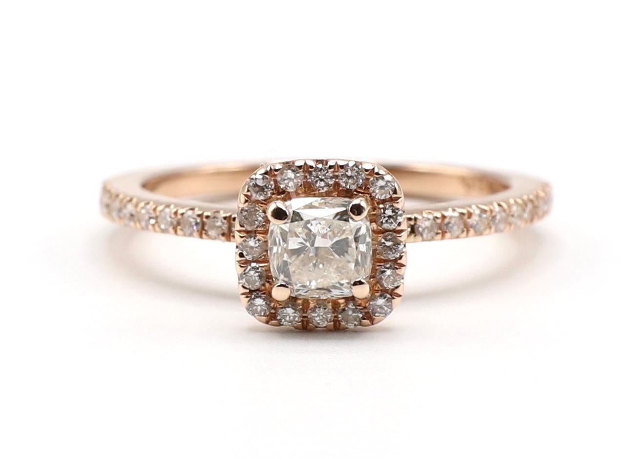 Vintage 14K Rose / Pink Gold 1/2 carat Diamond Cushion Halo Engagement Ring Size 6.25

Metal: 14K rose gold
Weight: 2.79 grams
Diamonds: 1 cushion cut diamond, approx. .50 cts, H SI, 39 small round diamonds on the band and halo, approx. .25 CTW G