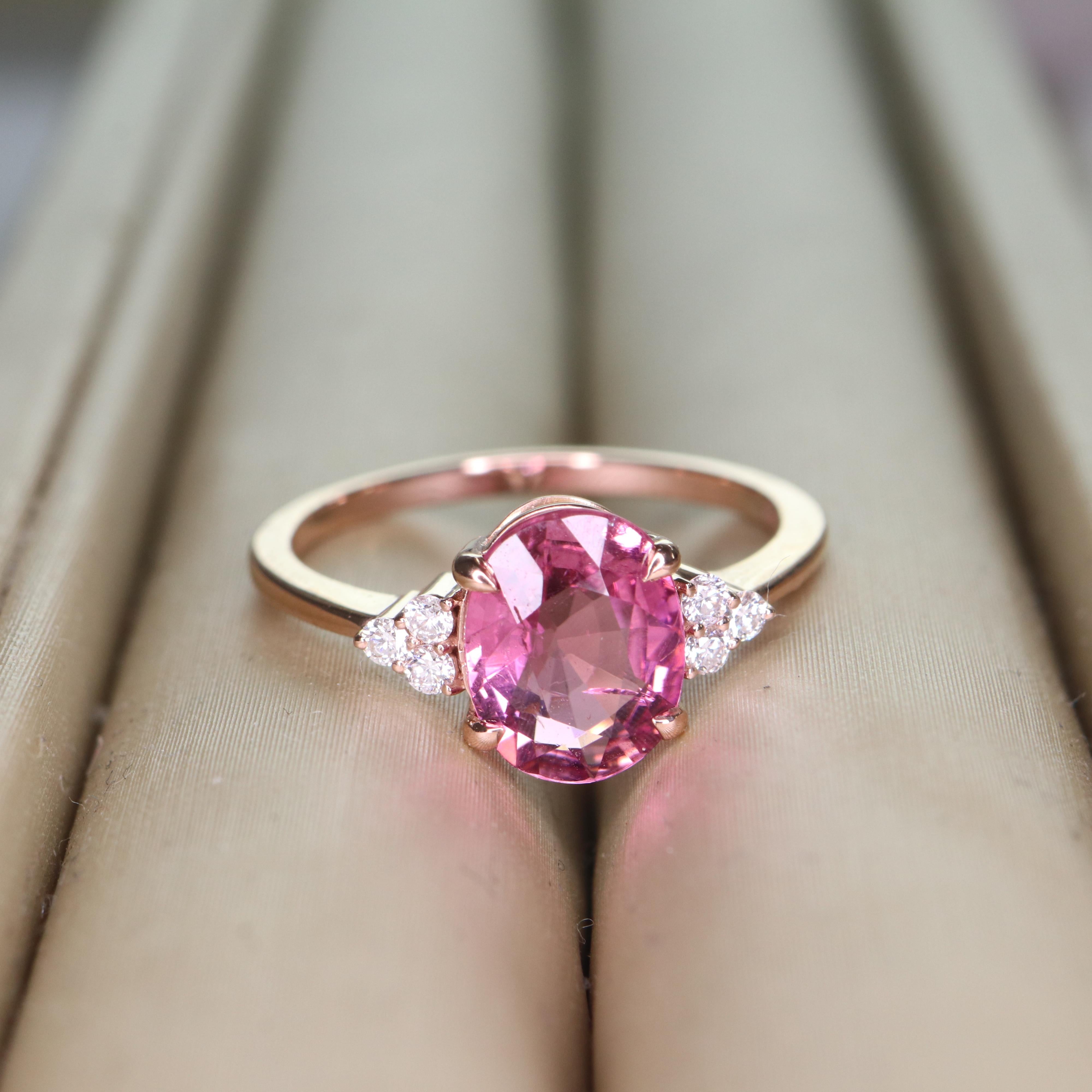 
Step into a realm of elegance with our 14K rose gold tourmaline ring, a masterpiece that embodies grace and sophistication. At its heart lies a mesmerizing pink tourmaline, radiating warmth and allure, perfectly complemented by the soft, romantic