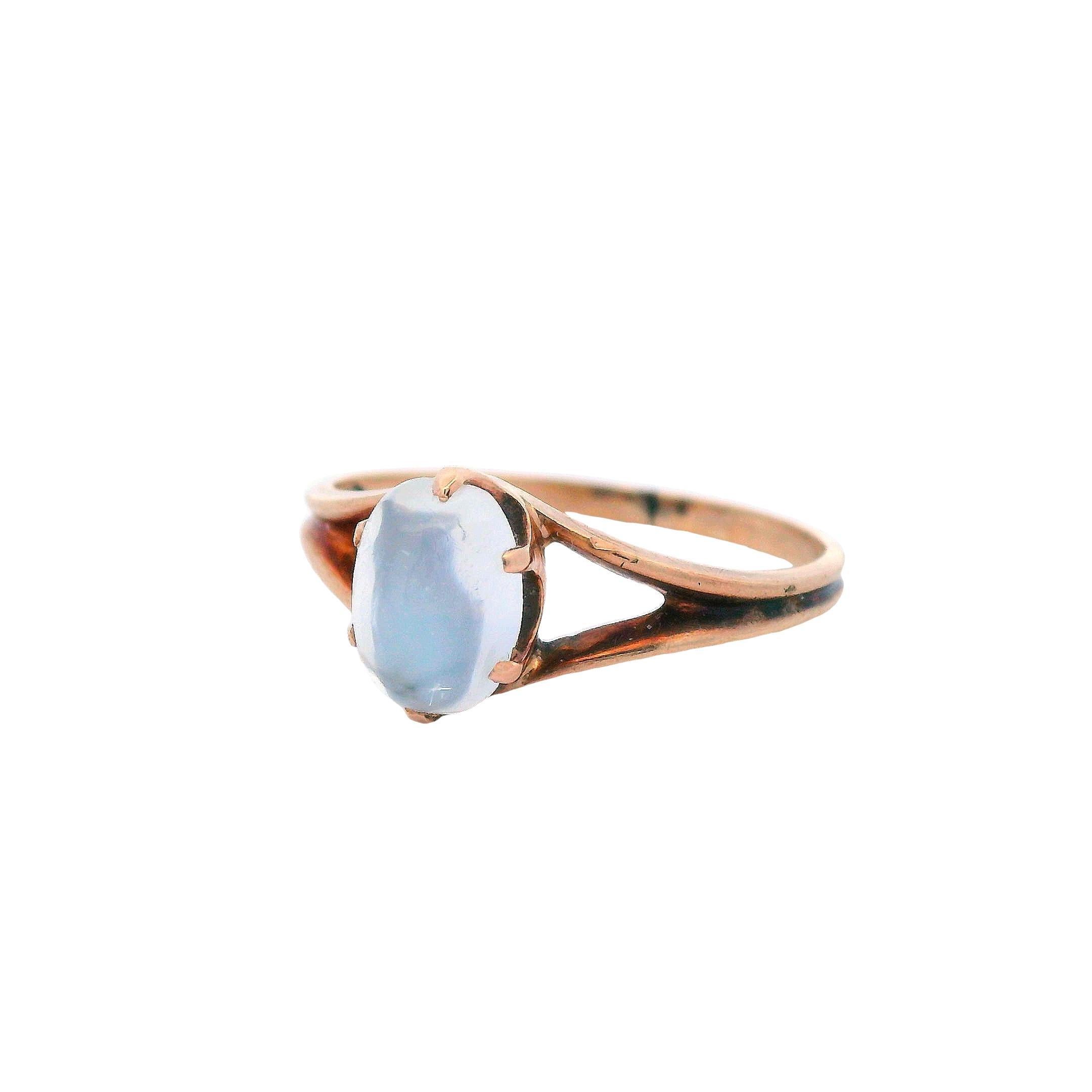 This is a beautiful 14k rose gold ring, featuring a cats eye moonstone cabochon, from the 1890 Victorian era. Cats eye moonstone gets its name from the parallel oriented fibers, or needle-like inclusions, that provide the 'cats eye' look within the