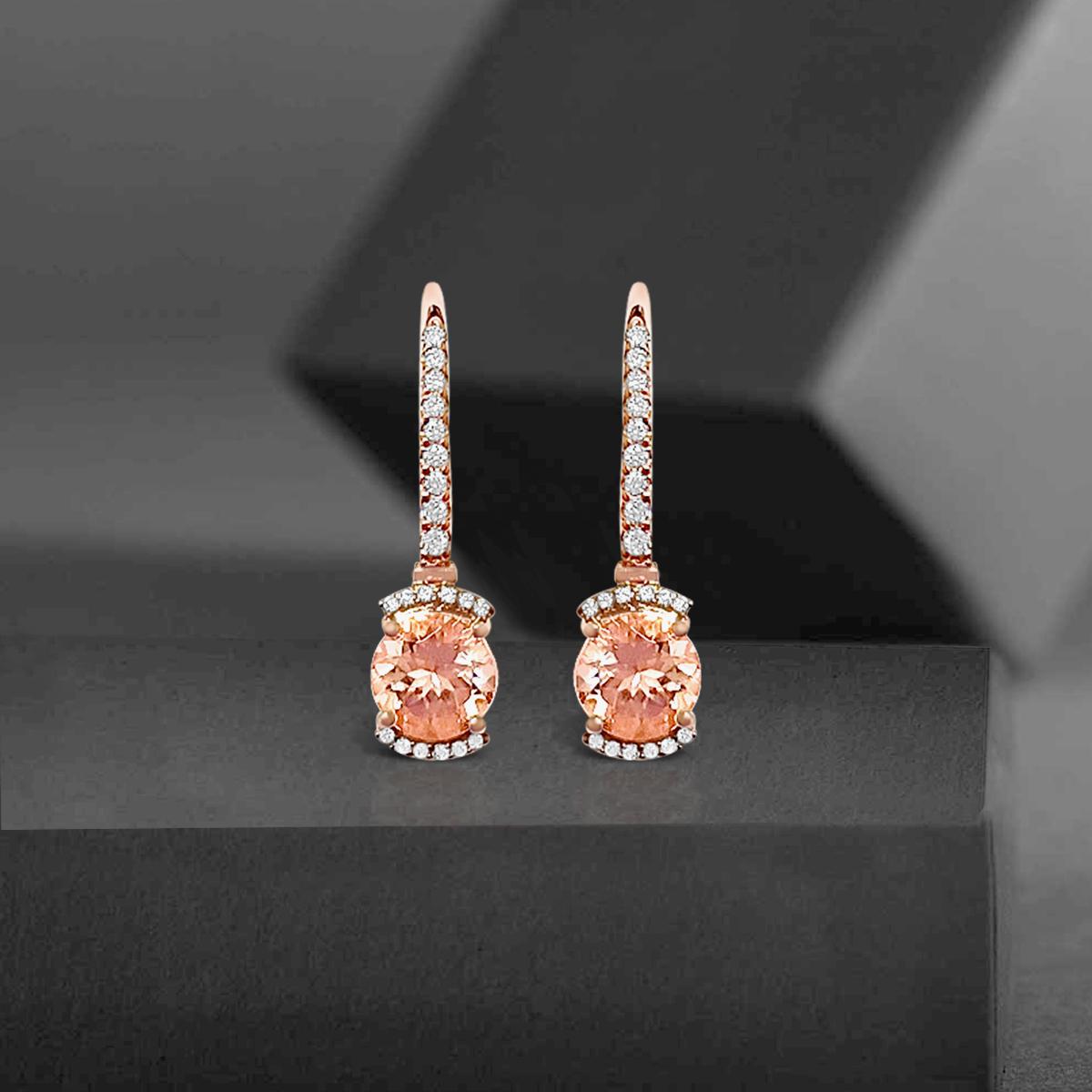 These Shimmering Dangle Earrings Features Round Shaped 7mm Morganite Gemstone And Dazzling Round Diamonds. This Classic Pair Is Set In 14K Rose Gold And Are Secured With Lever-Back Closures. The Stones Used Are Of True Gem Quality, The Metal Work Is