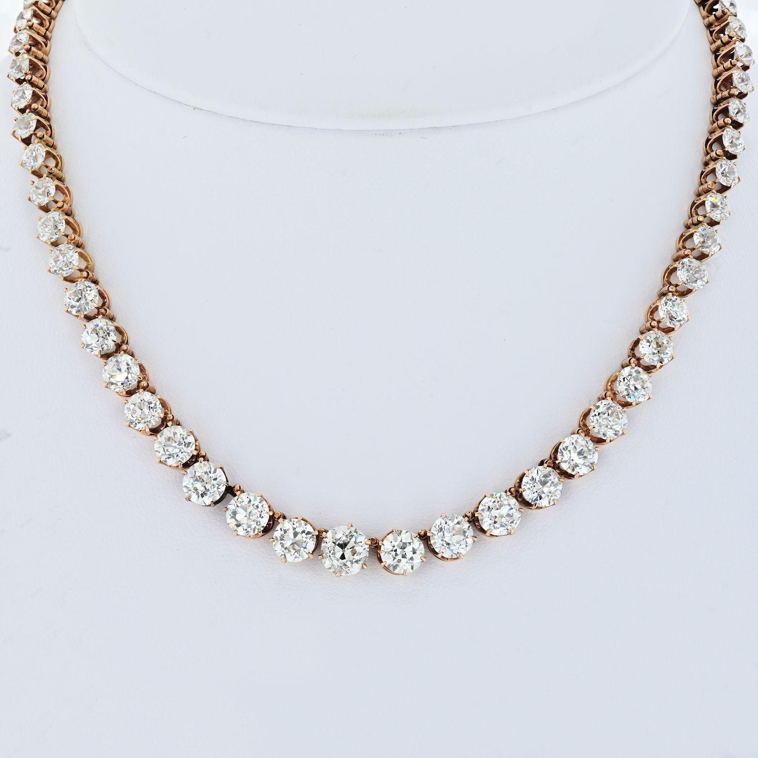 Diamond rivere necklace, mounted in rose gold baskets and connectors, composed of a single line of 64 graduated old mine cut diamonds weighing approximately 24.50 total carats, circa 1900s. With a fold down bail to accommodate a pendant or drop.