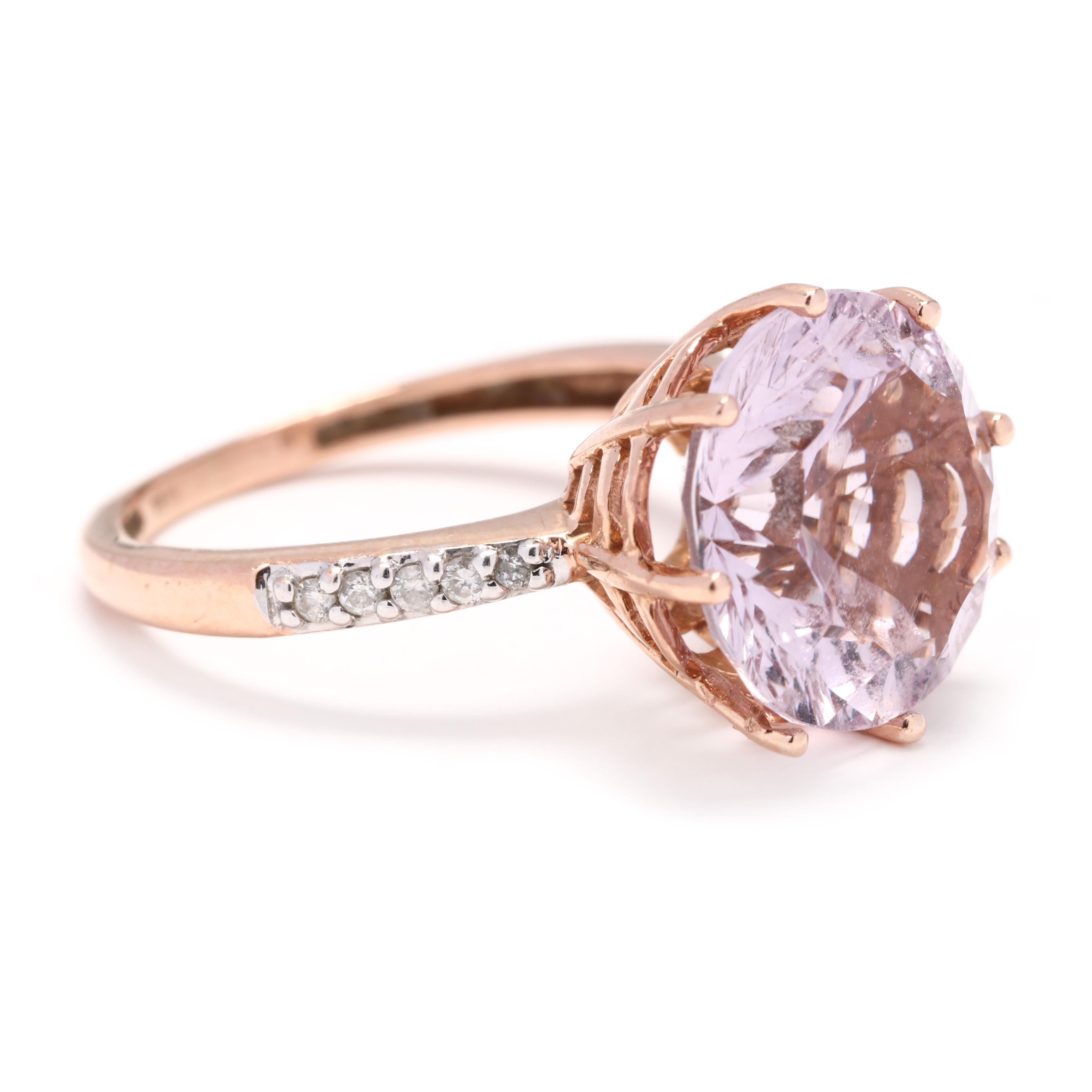 A 14 karat rose gold amethyst and diamond cocktail ring. This ring features a prong set, round brilliant cut light amethyst center stone with full cut round diamonds on either side weighing approximately .10 total carats and with a slightly tapered