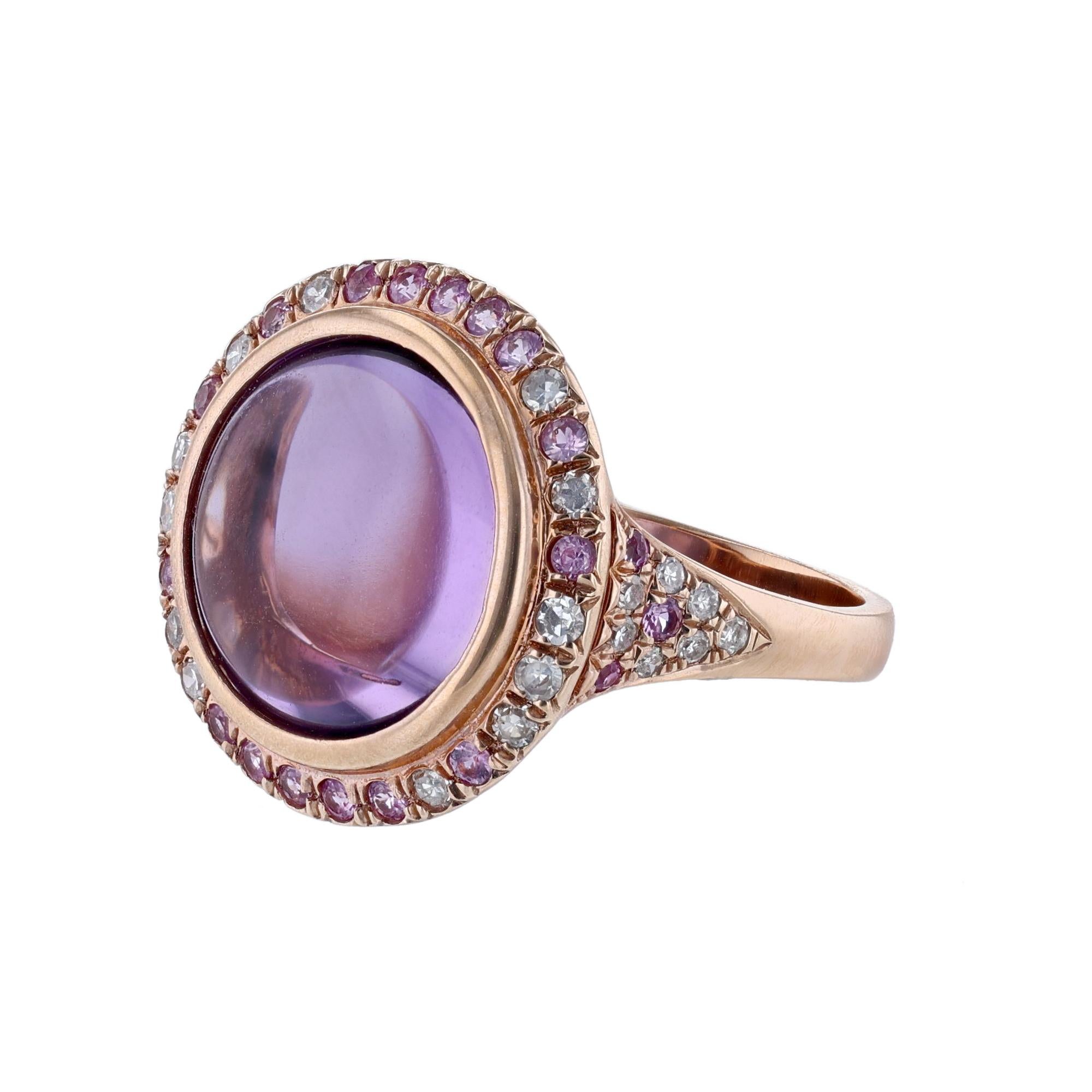 This ring is made in 14K rose gold and features 1 center round amethyst weighing 8.86 carats. Surrounded by a halo and shank of 22 pink sapphires weighing 0.34ct. and 26 diamonds weighing 0.29ct. 
