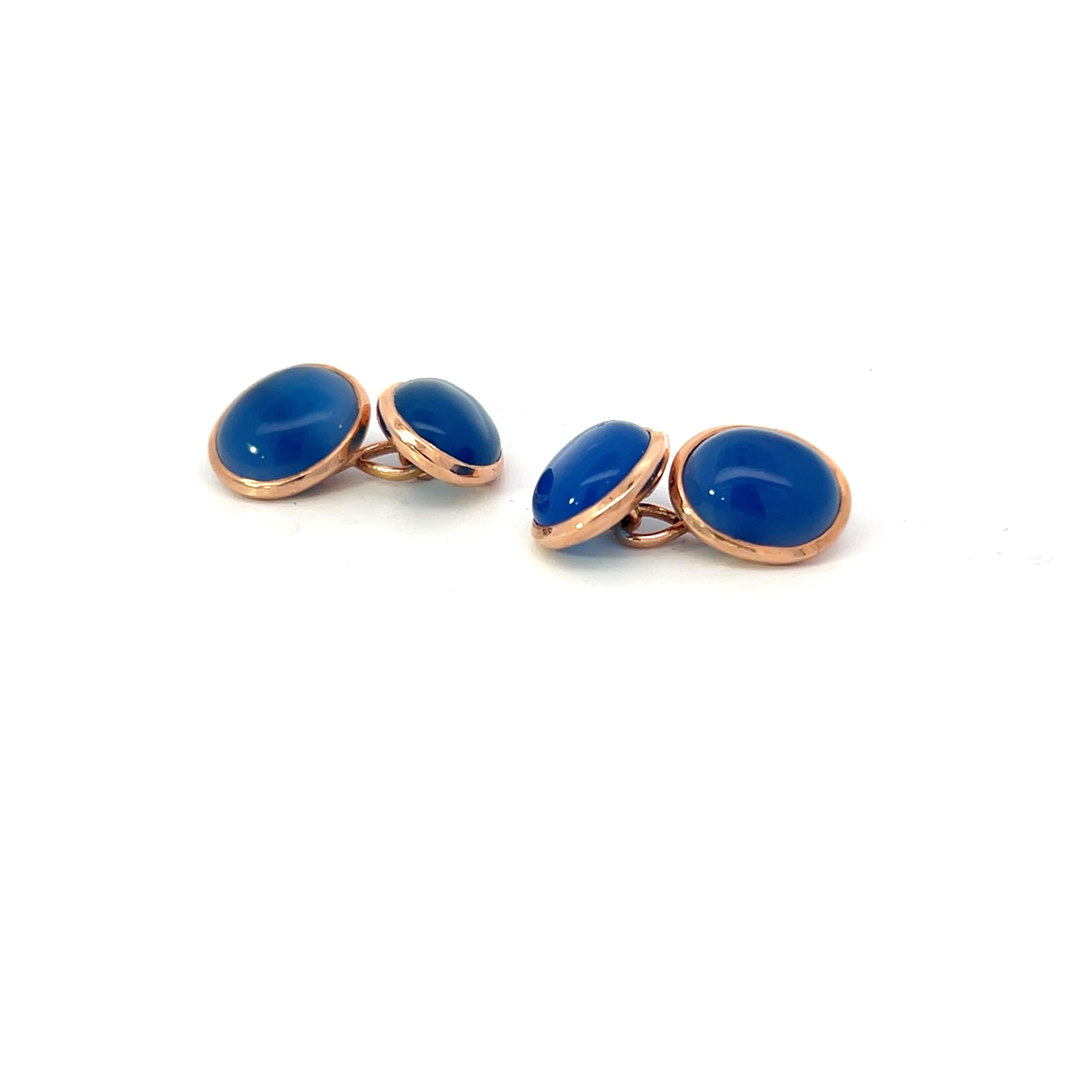 These sophisticated cufflinks feature oval blue onyx cabochons set in polished 14K rose gold, offering a timeless and refined look. Both sides of the double-sided design are identical, with rich blue onyx cabochons in smooth, oval shapes, creating a