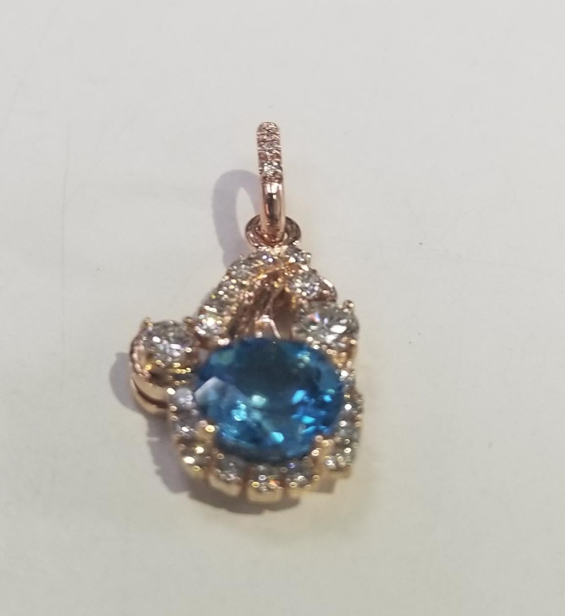 14k rose gold blue topaz and diamond pendant, .68pts in diamonds, no chain 