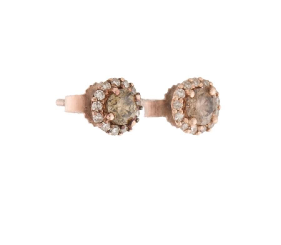 This is a gorgeous chocolate and white diamond earring stamped in solid 14K rose gold. The large and striking round brilliant chocolate diamonds have an excellent champagne/brown color. This is an attractive piece that will stand out in any room,