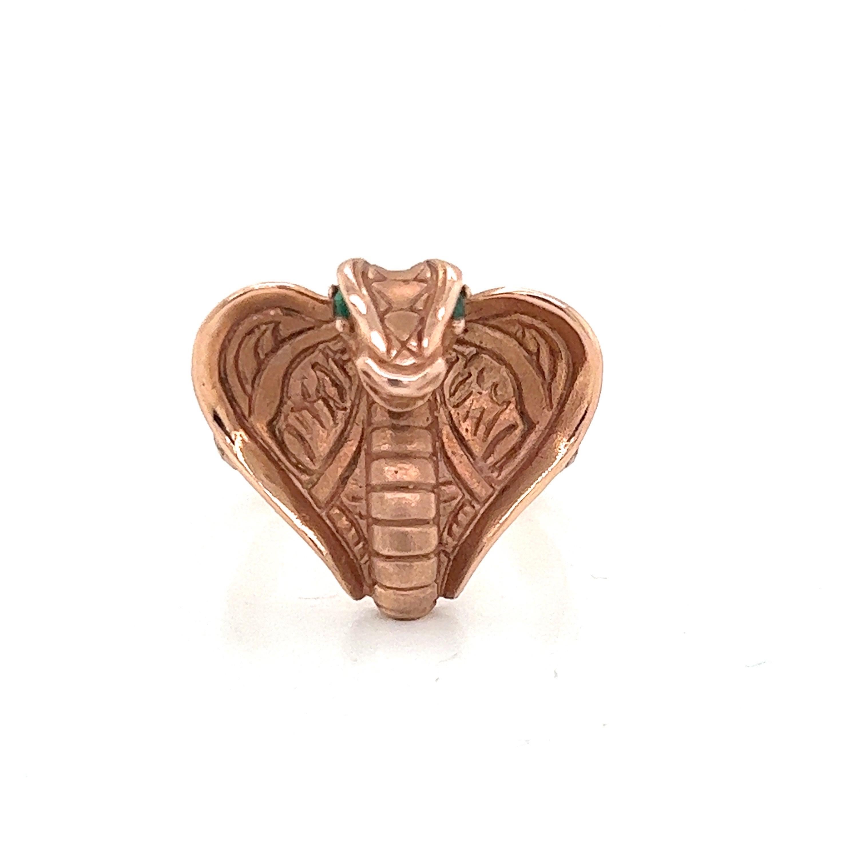14k pink gold Cobra ring with faceted emerald eyes. Handset gems