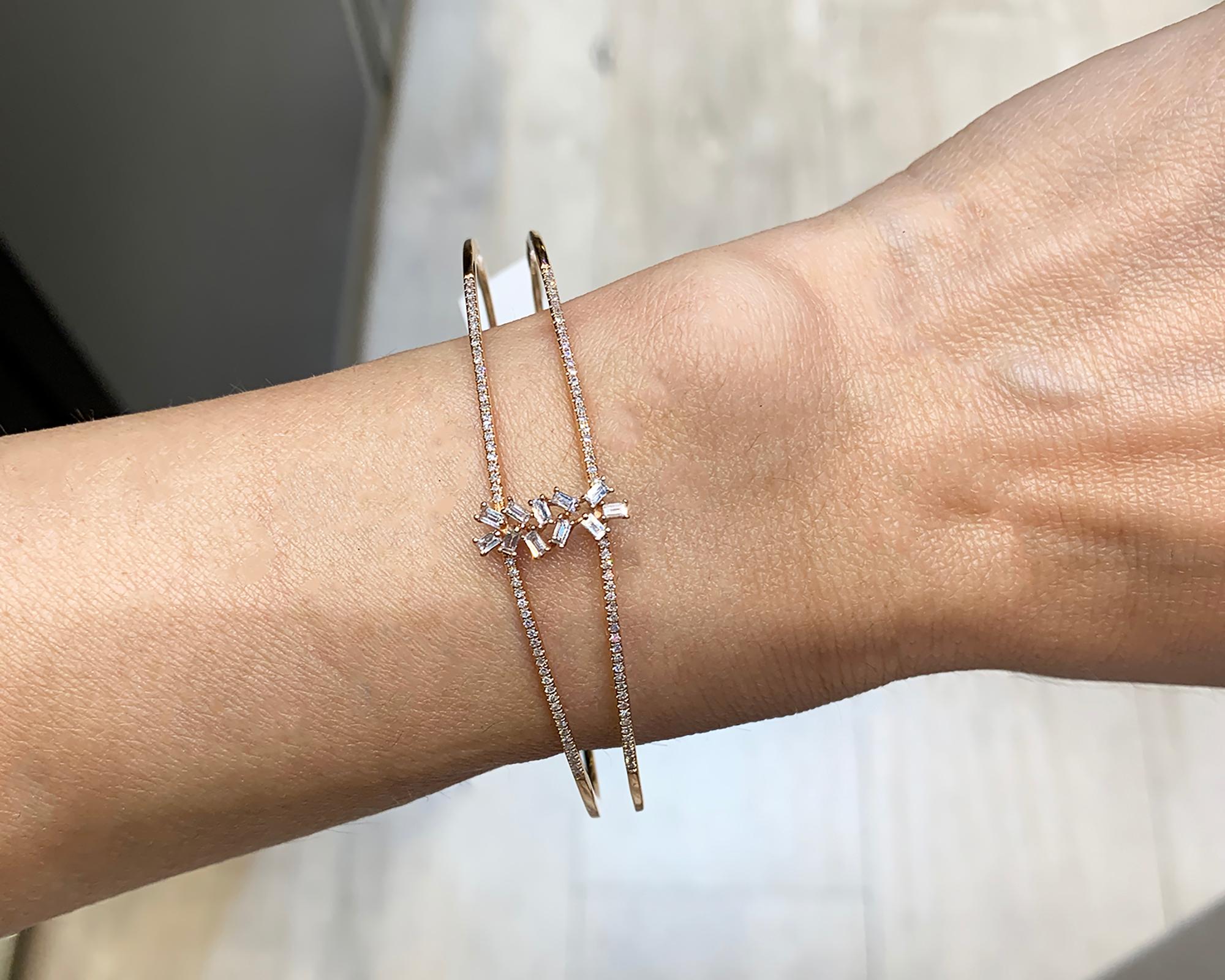 A cute bangle made in 14k rose gold and decorated with diamonds.
11 baguette diamonds weighing 0.28 carats.
100 round diamonds weighing 0.25 carats.
Total diamond weight is 0.53 carats.
14k rose gold weighs 8.65 grams.