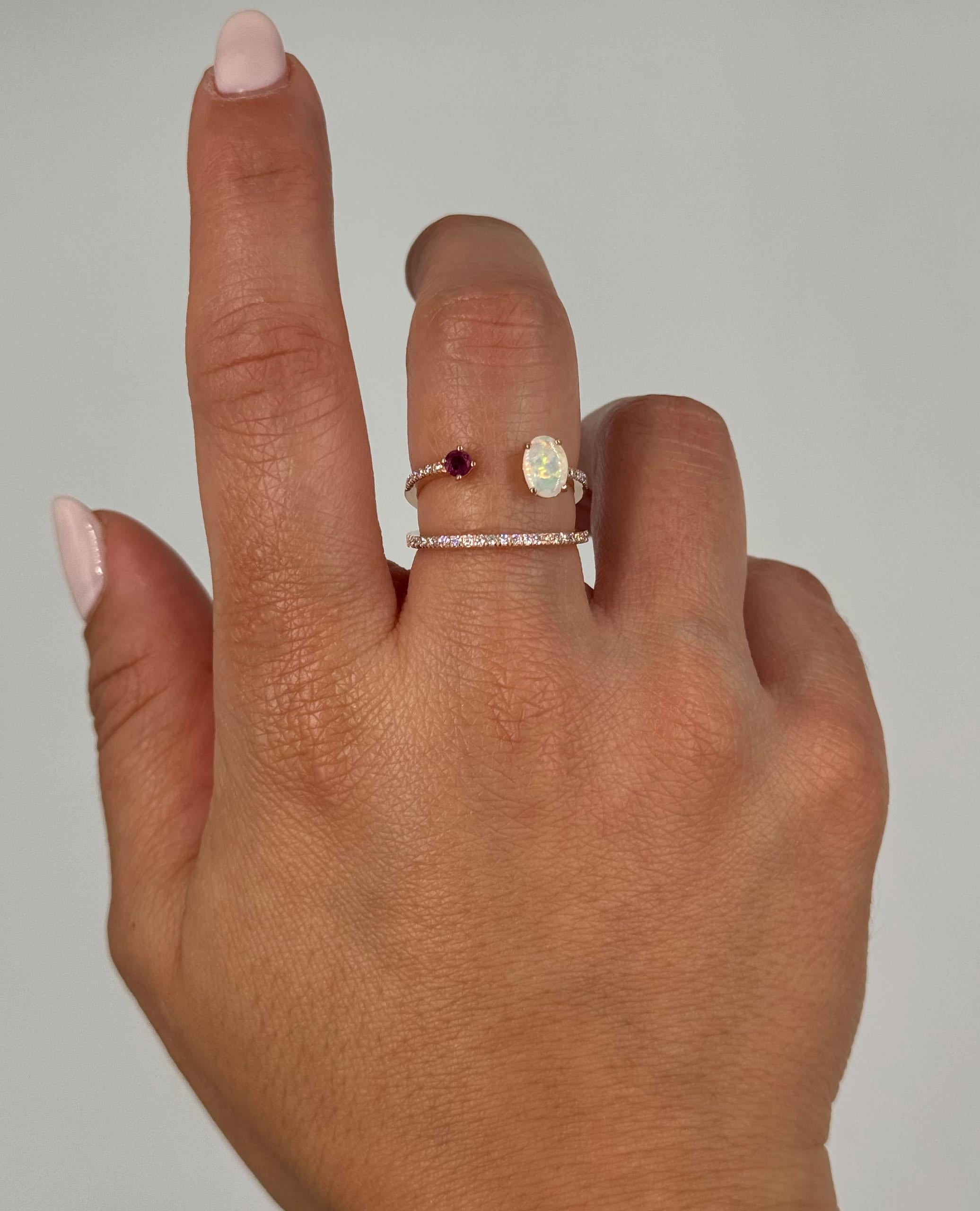 14K rose gold fashion ring with one oval opal weighing 0.31 carats, one round faceted ruby weighing 0.17 carats, and 44 round faceted diamonds weighing 0.23 carats total.   

- Finger size 7, can be sized up or down by up to two sizes