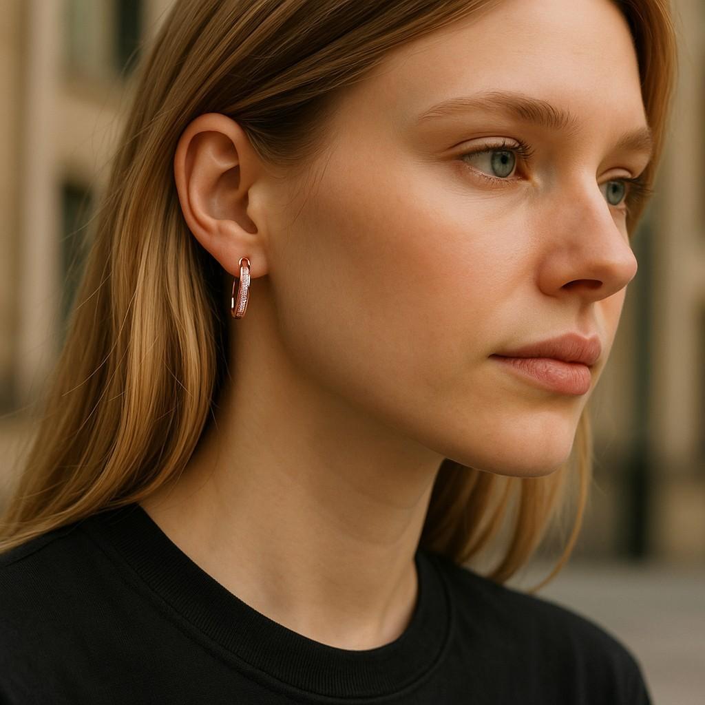 Delicate sophistication meets everyday luxury in these 14K Rose Gold Diamond Oval Huggie Hoop Earrings, designed for the modern woman who values both elegance and versatility. Set in romantic 14K rose gold (stamped 585), each earring sparkles with