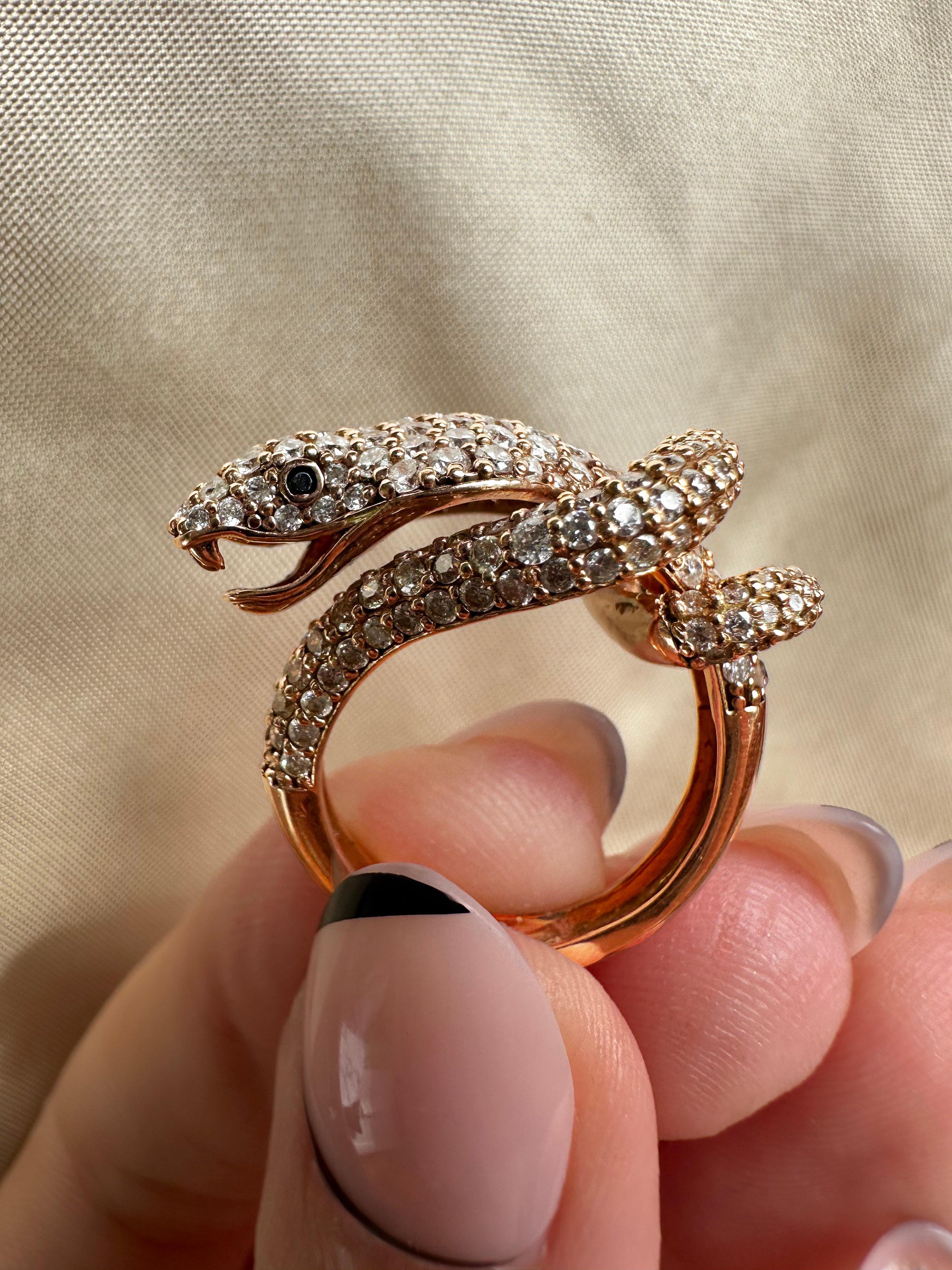 Serpent-shaped ring set with 2.43 carats of diamonds and black diamond eyes. 14K rose gold, stamped 