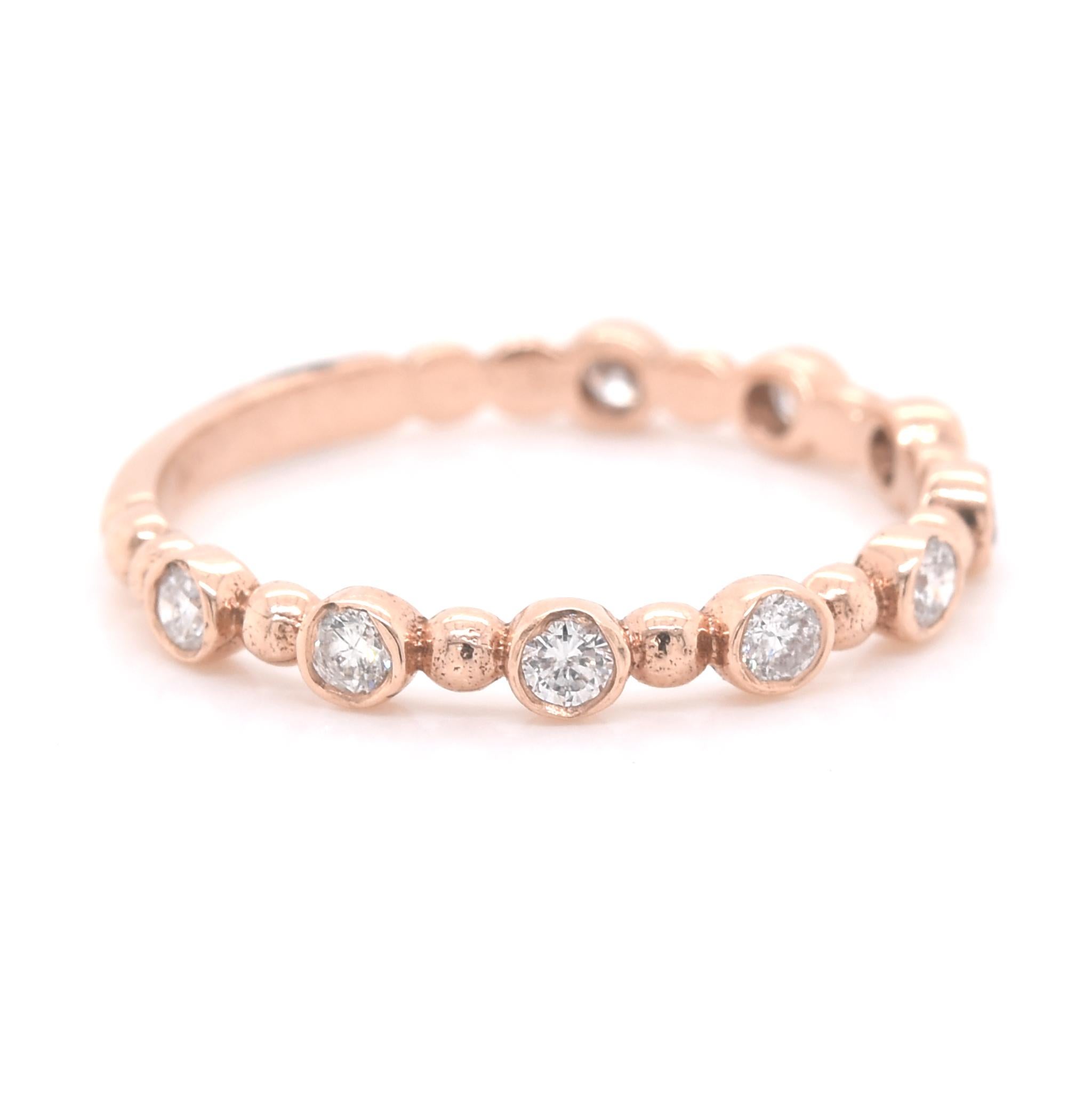 Designer: custom
Material: 14k rose gold
Diamonds: 9 round brilliant cuts = 0.28cttw
Color: I
Clarity: SI1-SI2
Size: 5 ½ 
Dimensions: ring is 2.35mm in width
Weight: 1.30 grams
