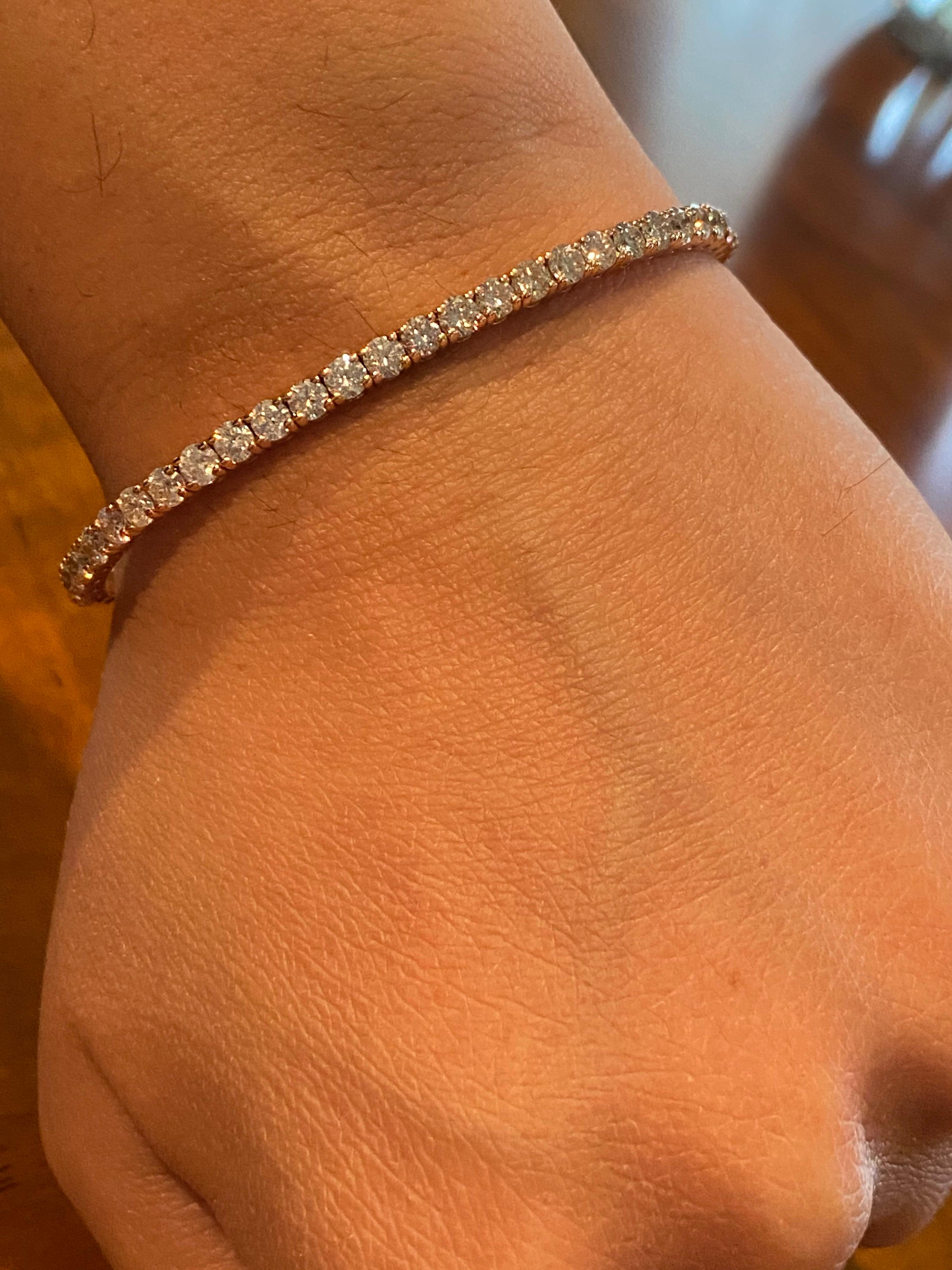 Flexible diamond bangle set in 14K rose gold. This Italian made bangle is set halfway of stones each weighing approximately 0.10 carats each. The diamonds are G color, SI1-SI2 clarity and the total weight is 3 carats. This bangle is available in