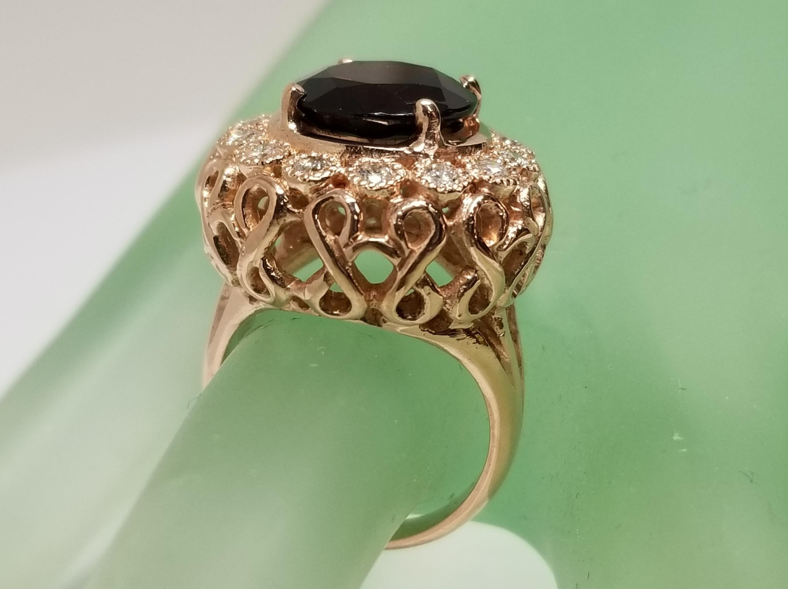 14k rose gold garnet and diamond domed ring, containing 1 round garnet of gem quality weighing 5.45cts. and 14 round full cut diamonds weighing .60pts.  This ring is a size 6 but we will size to fit for free.