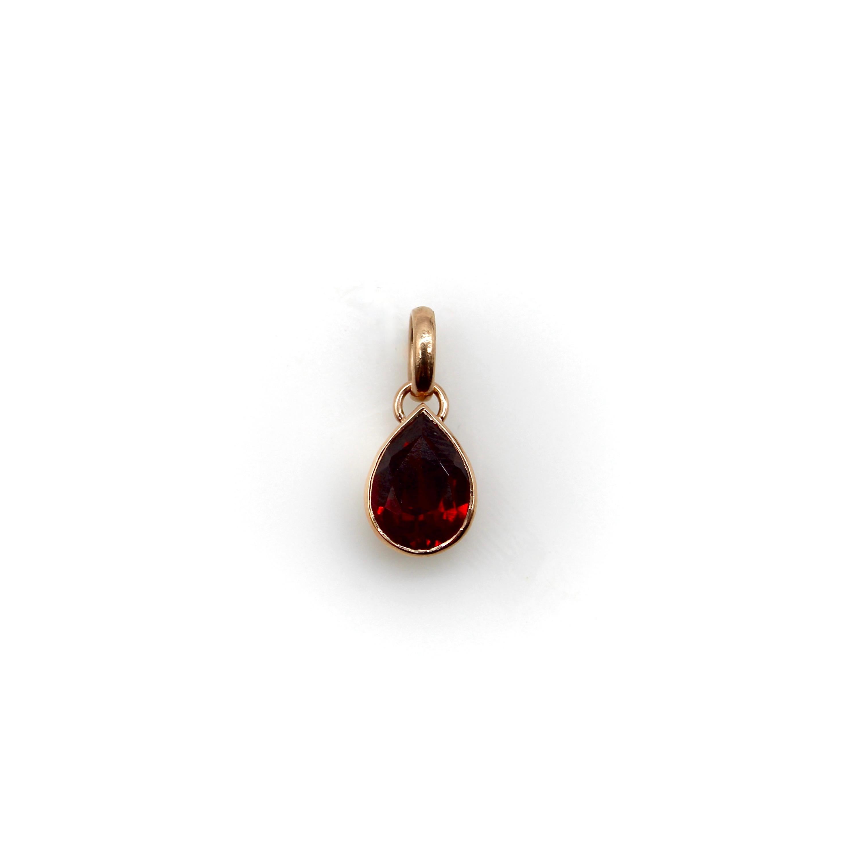 This beautiful pear-shaped garnet is bezel set in 14k rose gold. The vibrant red hues of the sparkling garnet are accentuated by the subtle pink tones of the rose gold, making this a lovely piece. The pendant has an oval bail, allowing the garnet to
