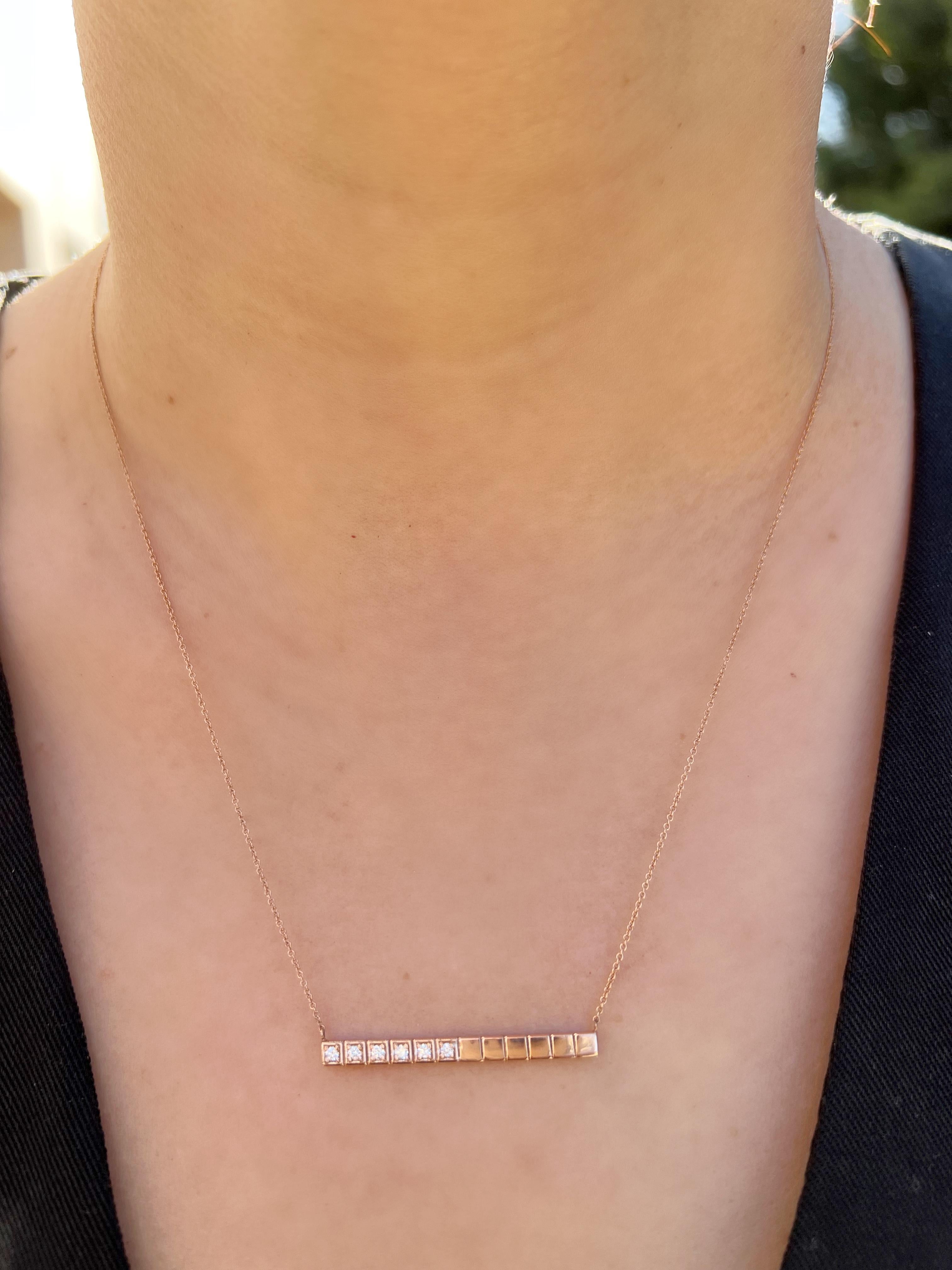 Crafted in 14K gold and round glistening diamonds, this Pendant is completed with a bar of geometric cubes, half encrusted with shimmering diamonds to create a modern feel. This stunning gold bar necklace is a simple piece that sits elegantly above