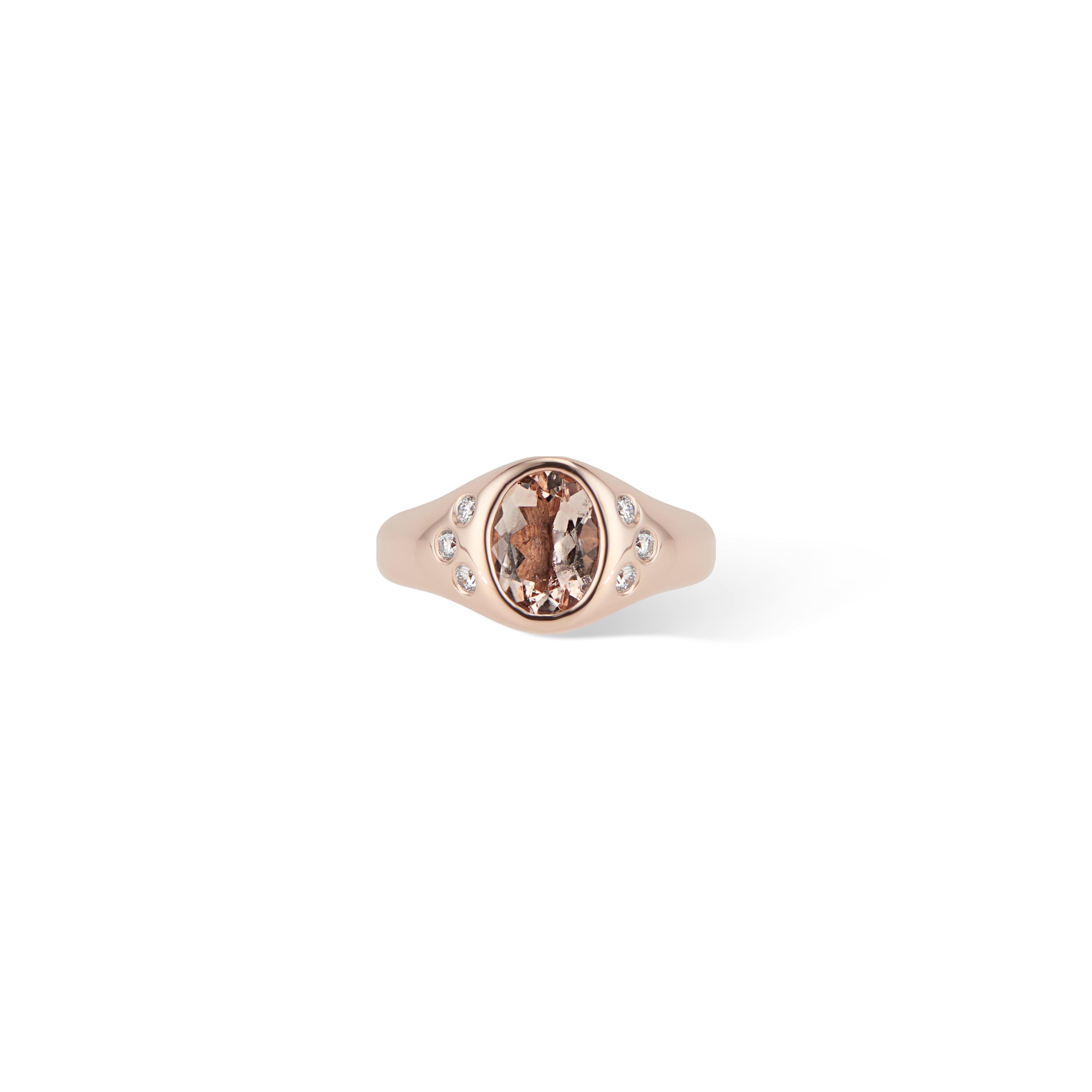 This stunning rose gold morganite and diamond ring is a modern update on the classic signet pinky ring.

Featuring a beautiful peach hued oval morganite and 6 sparkling white diamonds all bezel set in a high polished rose gold setting, this ring