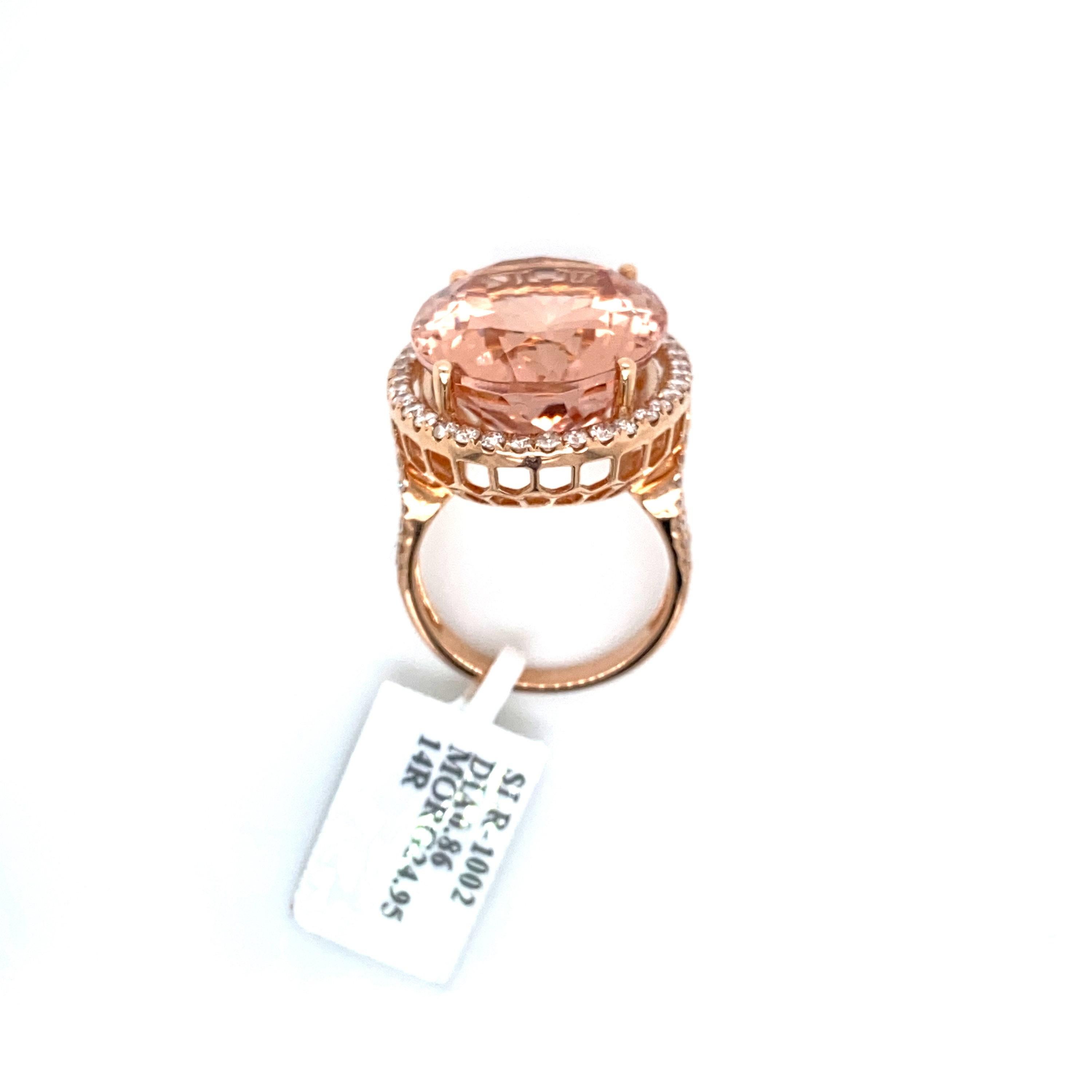 This is a magnificent natural morganite and diamond cocktail ring set in solid 14K rose gold. The natural 20X17MM 24.95ct morganite oval has an excellent peachy pink color and is set on top of a gorgeous diamond encrusted shank. The ring is stamped