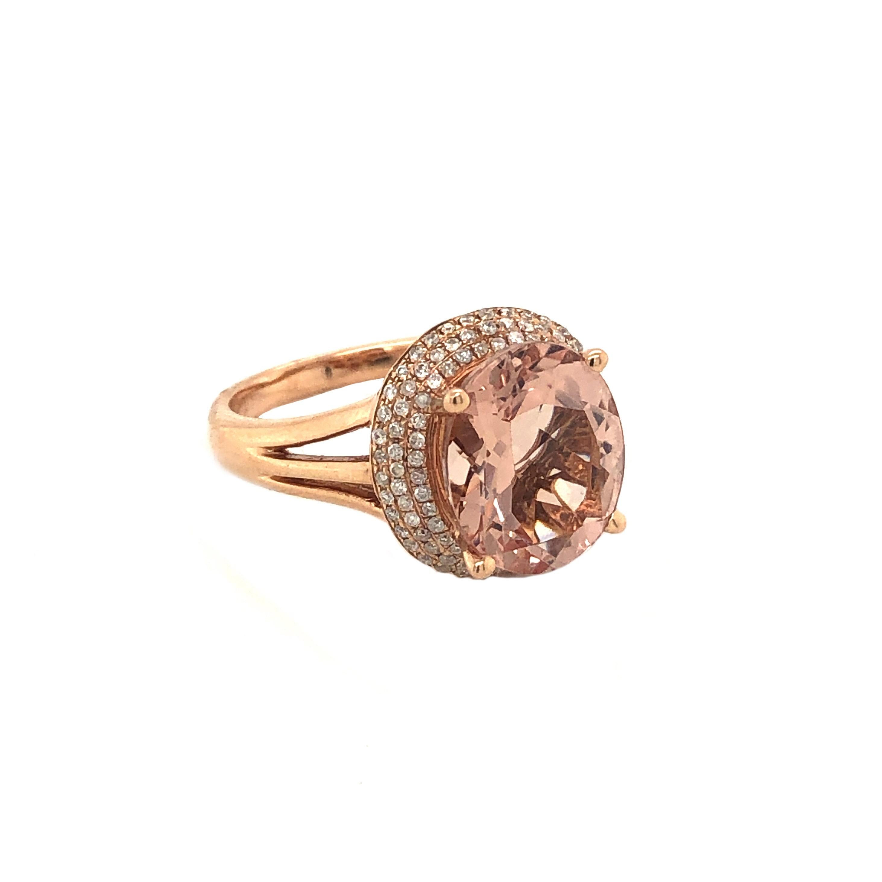 This is an alluring natural morganite and diamond ring set in solid 14K rose gold. The natural 2.94 Ct oval cut morganite has an excellent peachy pink color and is surrounded by a triple halo of round cut white diamonds. The ring is stamped 14K and