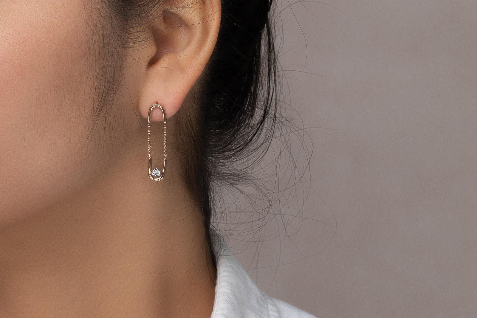 Arguably our most unique jewelry design in our collection, the Paperclip Dangling Diamond Earrings are a guarantee conversation starter. The name of these dangling diamond earrings comes from, not only the resemble to paperclips, but also their