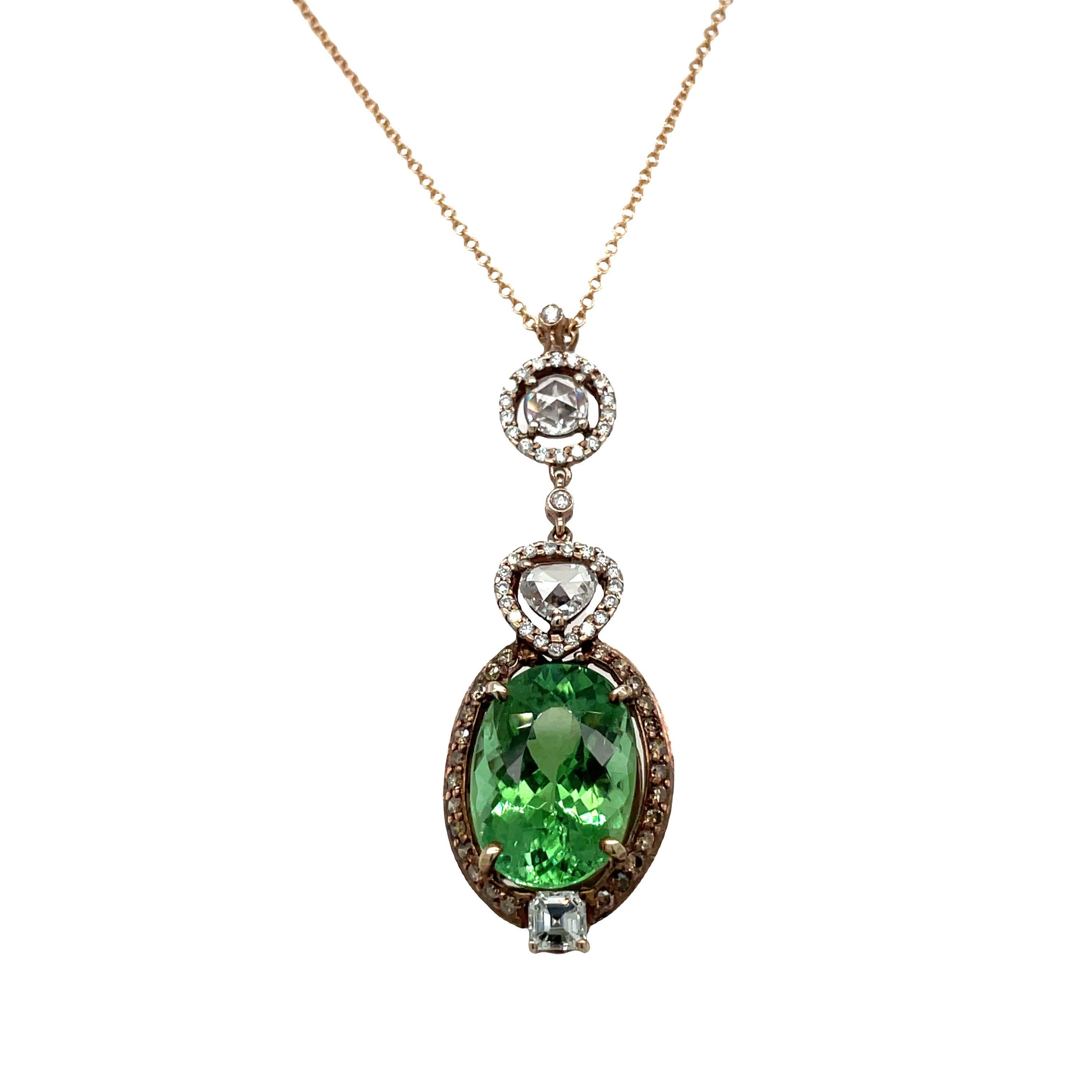 A stunning natural 9 carat Mozambique Paraiba tourmaline and diamond pendant necklace. The striking green of the tourmaline is beautifully set off in a 14 karat rose gold and old cut diamond mounting surmounted by rose cut heart and round shaped