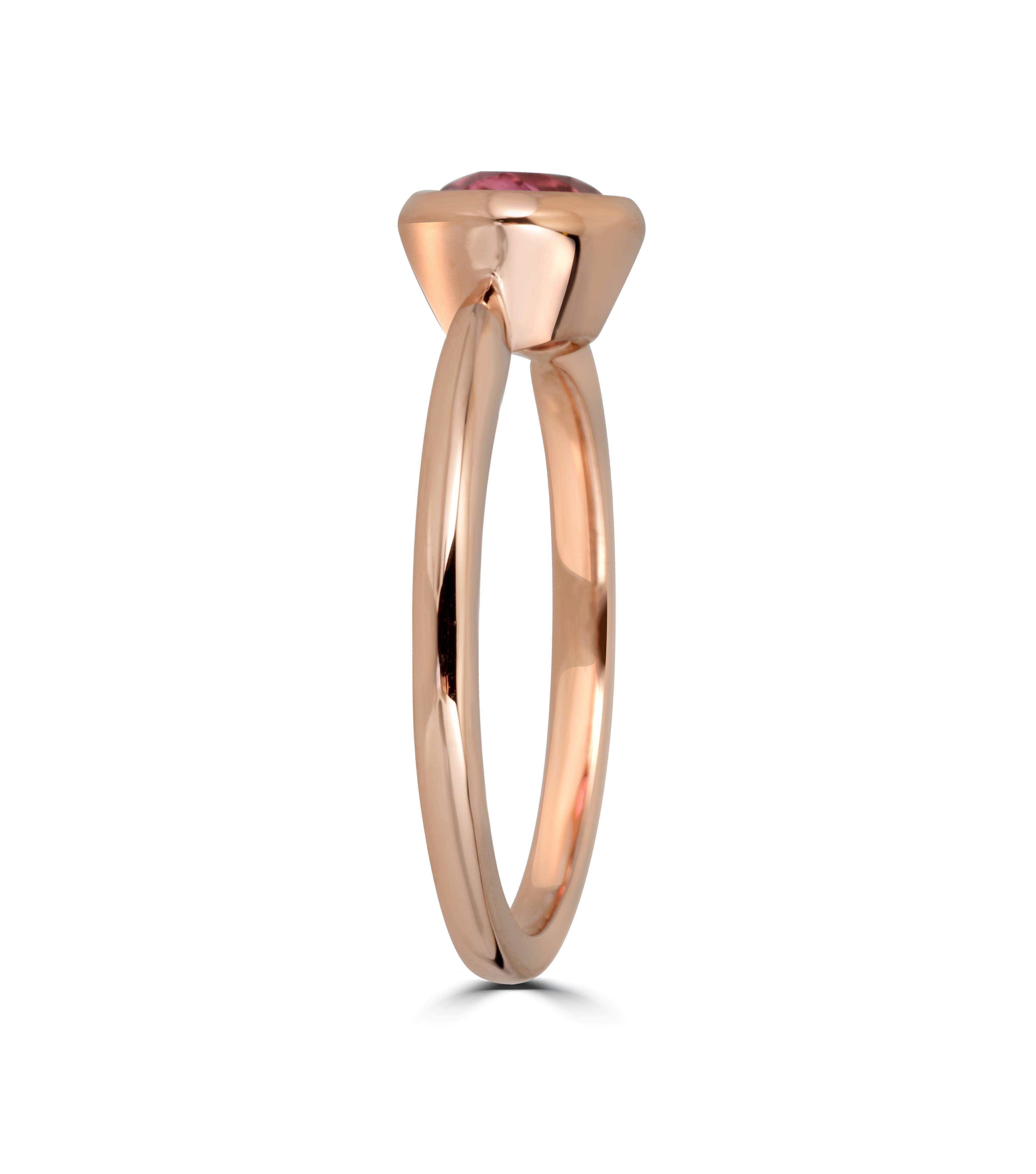 This ring features a bright pink oval tourmaline set in a East to West Horizontal bezel setting to create a decidedly modern and fresh aesthetic.

Perfect to be worn alone or stacked with other rings, this pieces adds a touch of effortless luxury to