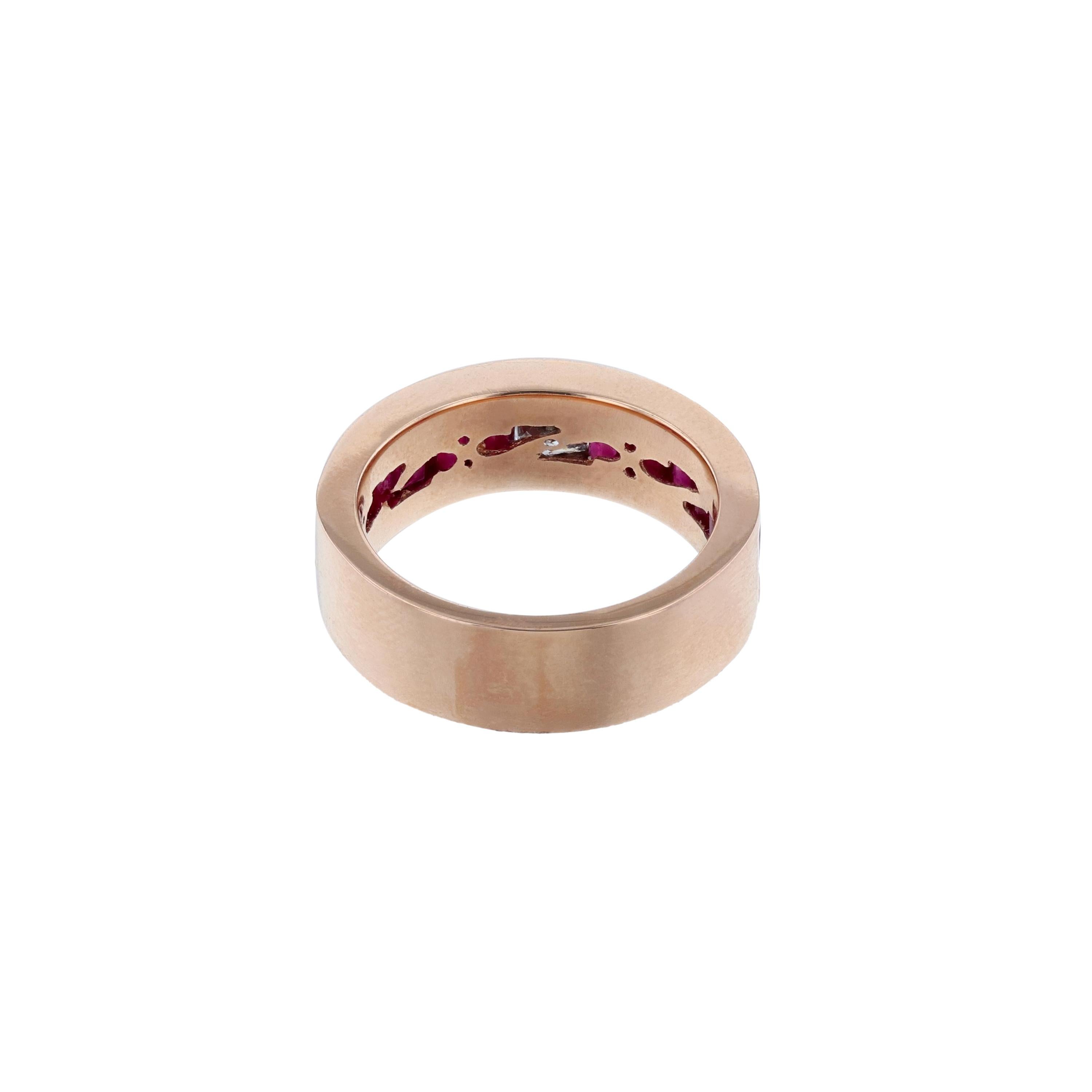 This ring is made in 14K rose gold and features 1 princess cut diamond weighing 0.30 carat. It also features 12 baguette cut rubies weighing 3.30. All stones are channel set and weigh 3.60 carats combined with a  color grade (H) clarity grade (SI2). 
