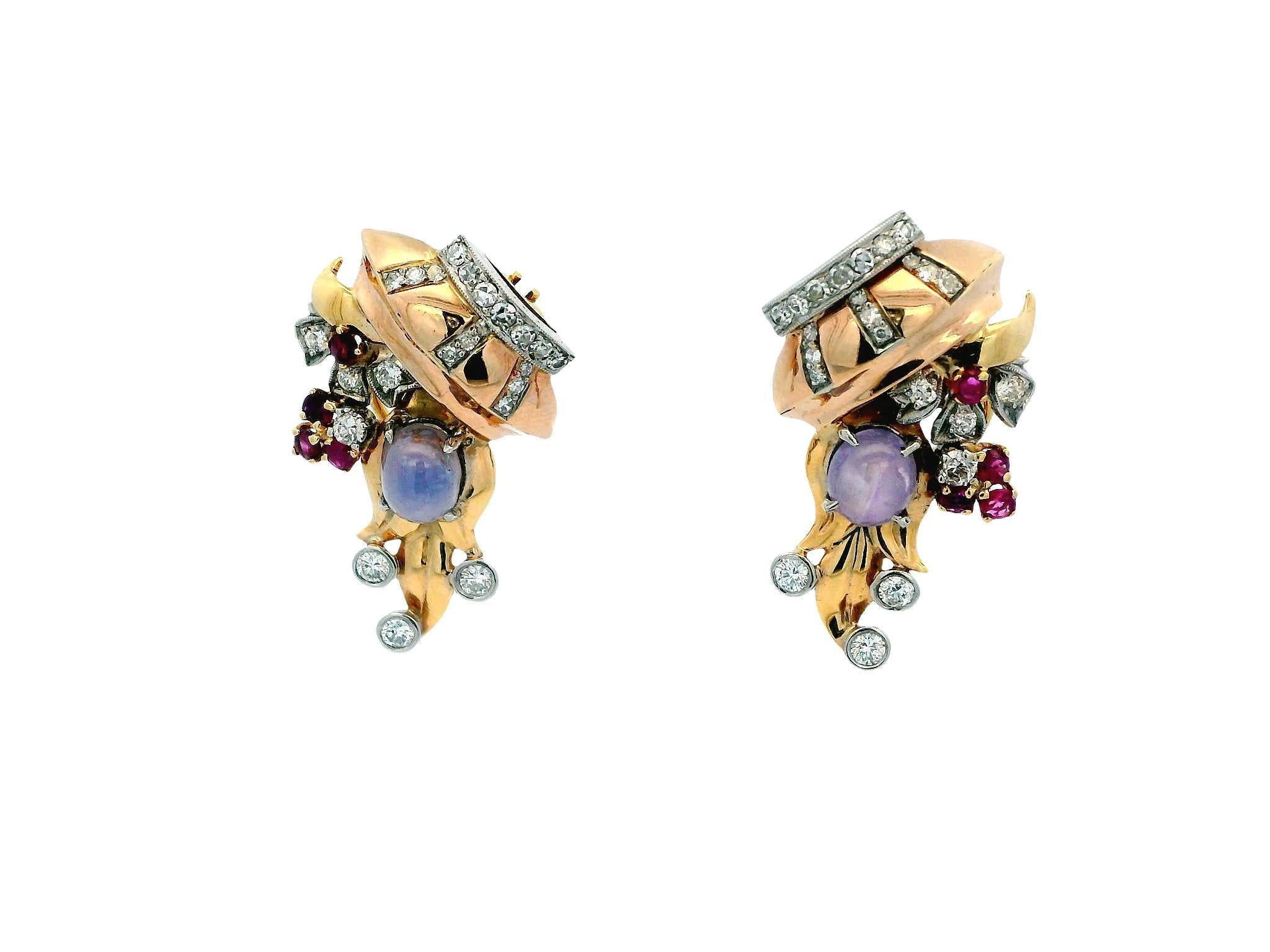 These exquisite retro earrings are a striking statement piece, beautifully crafted from 14k rose gold. The earrings each feature a stunning cabochon-cut blue star sapphire, weighing 1.0 carat, which captivates with its unique star-like reflection.