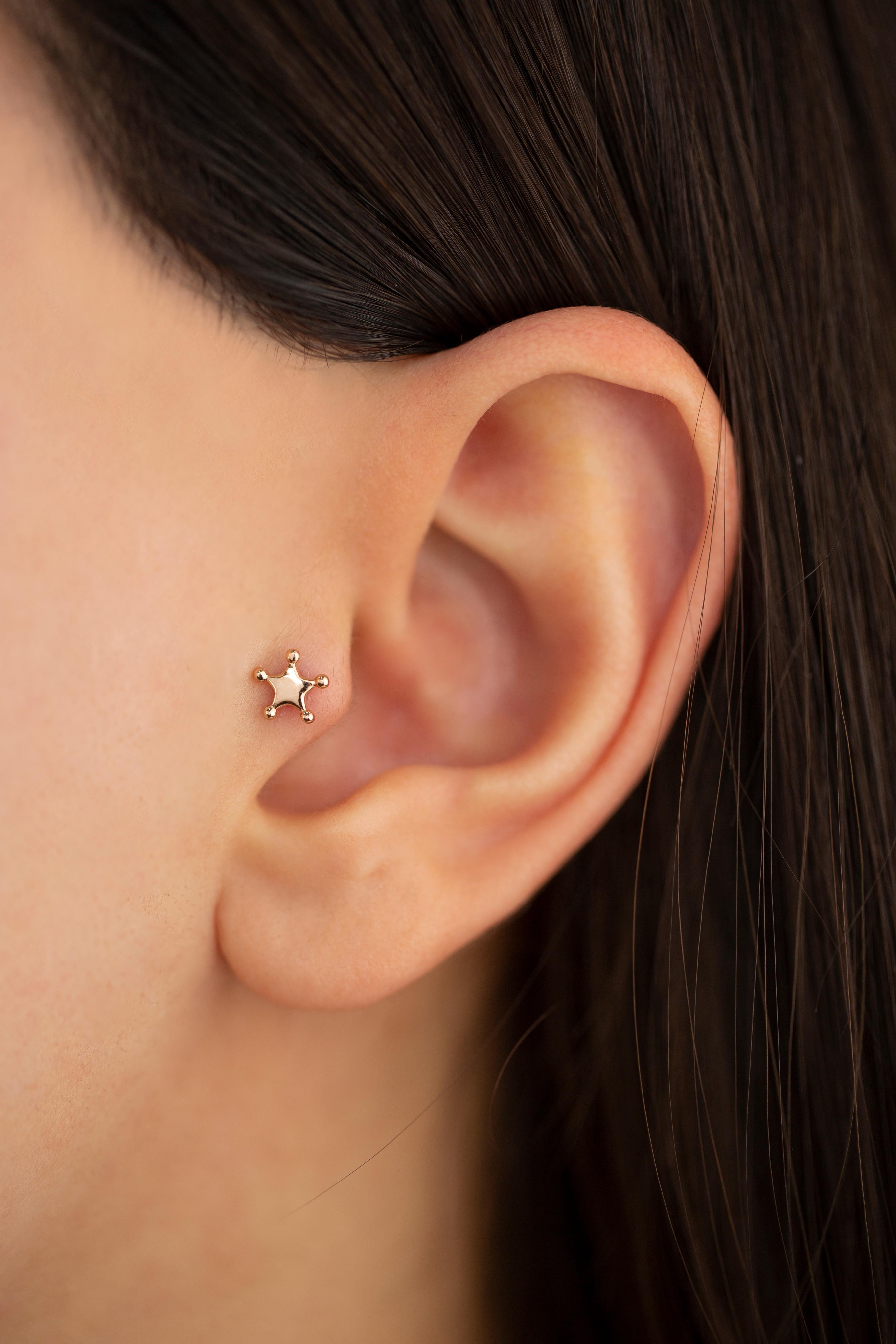14K Rose Gold Sheriff Star Piercing, Rose Gold Stud Sheriff Badge Earring

You can use the piercing as an earring too! Also this piercing is suitable for tragus, nose, helix, lobe, flat, medusa, monreo, labret and stud.

This piercing was made with