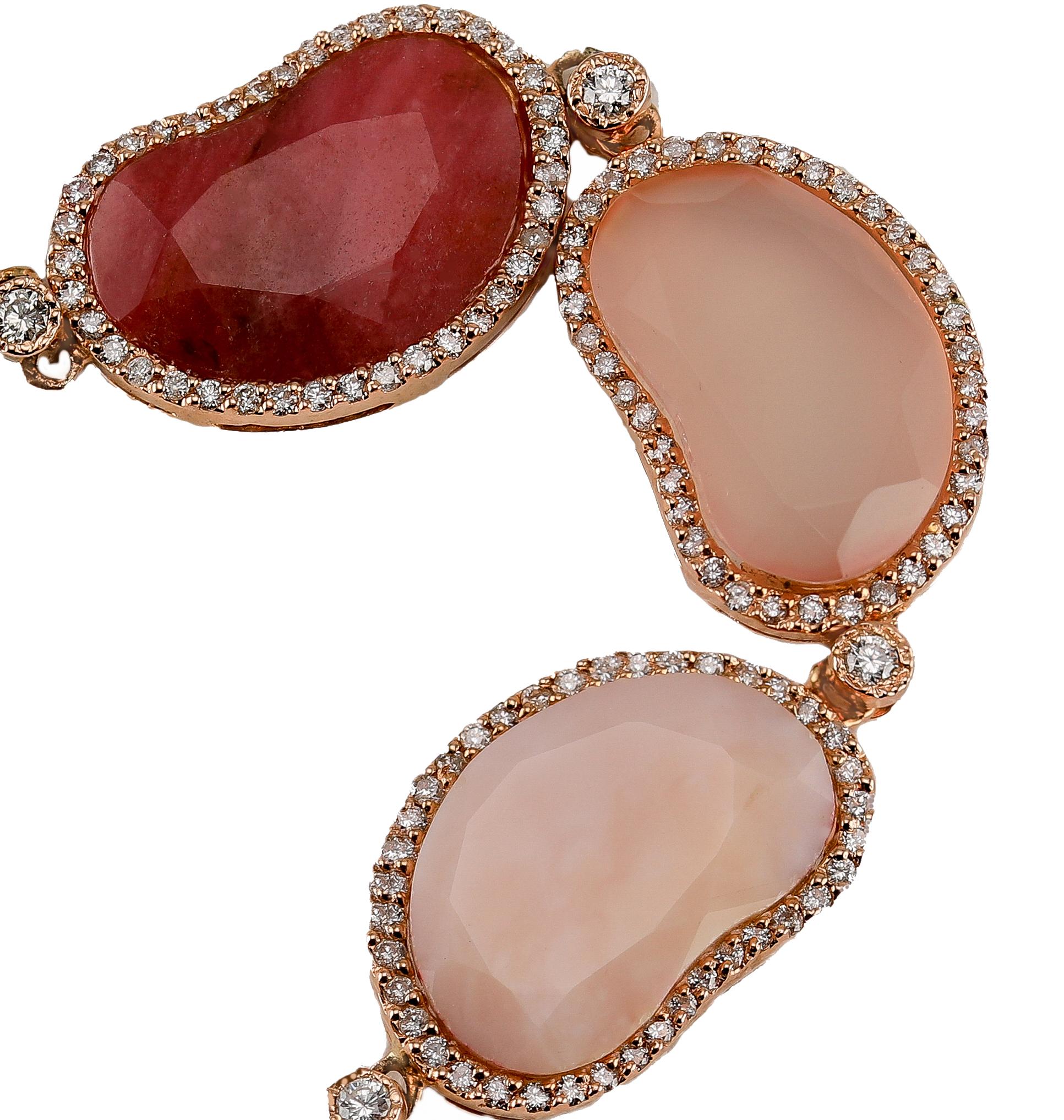 14k Rose Gold Sliced Pink Agate Ruby Rose Quartz Pink Bean Diamond Bracelet

A beautiful bracelet consisting seven sliced cut stones, of rose quartz, ruby, and agate. each stone is shaped like a bean and highlighted with a halo of diamonds totaling