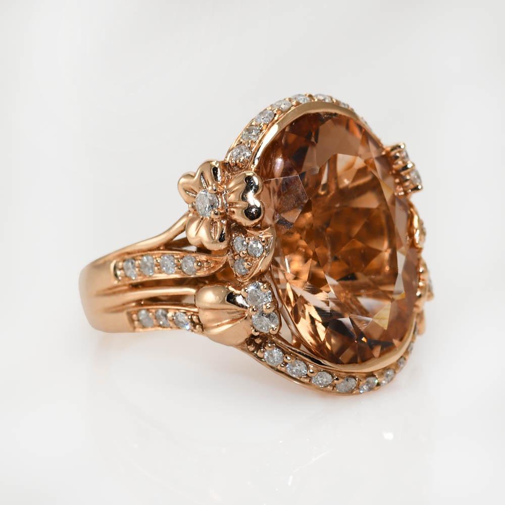 Ladies 14k rose gold , beryl and diamond ring.

Stamped 14k and weighs 7.8 grams, 5.4 grams without the stone.

The main stone tests synthetic beryl, oval shape, light yellowish-brown, 17.5 x 13.5 x 9mm.

There are round brilliant cut diamonds on