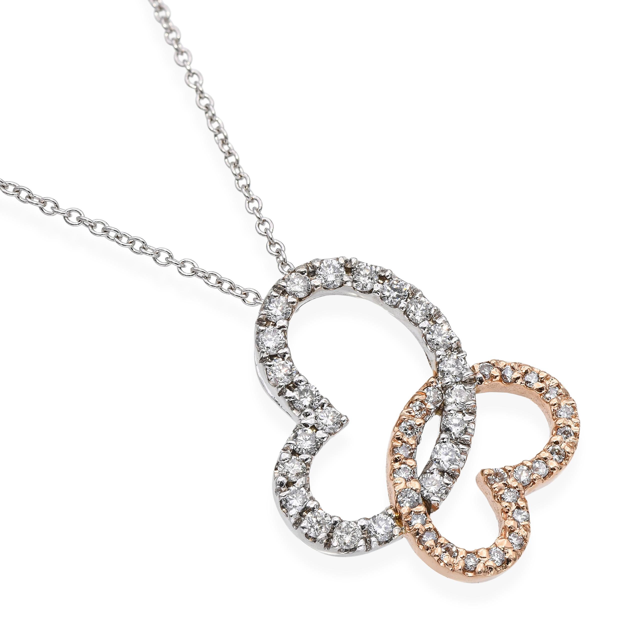 Celebra l'amore senza tempo e l'eleganza moderna con questa straordinaria collana di cuori intrecciati in oro rosa e bianco 14K, un pezzo a doppia tonalità che simboleggia splendidamente la connessione e l'armonia. I due cuori, uno in caldo oro rosa