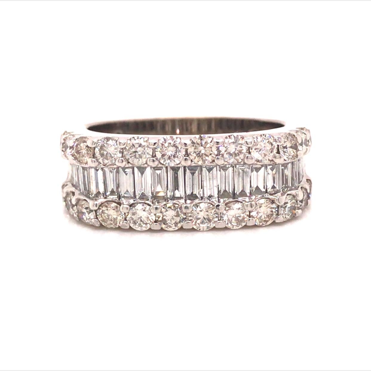 Round and Baguette Diamond Band in 14K White Gold.  (24) Round Brilliant Cut and (20) Baguette Diamonds weighing 3.03 carat total weight, G-H in color and VS-SI in clarity are expertly set.  The Ring measures 3/8 inch in width.  Ring size 9.  7.45