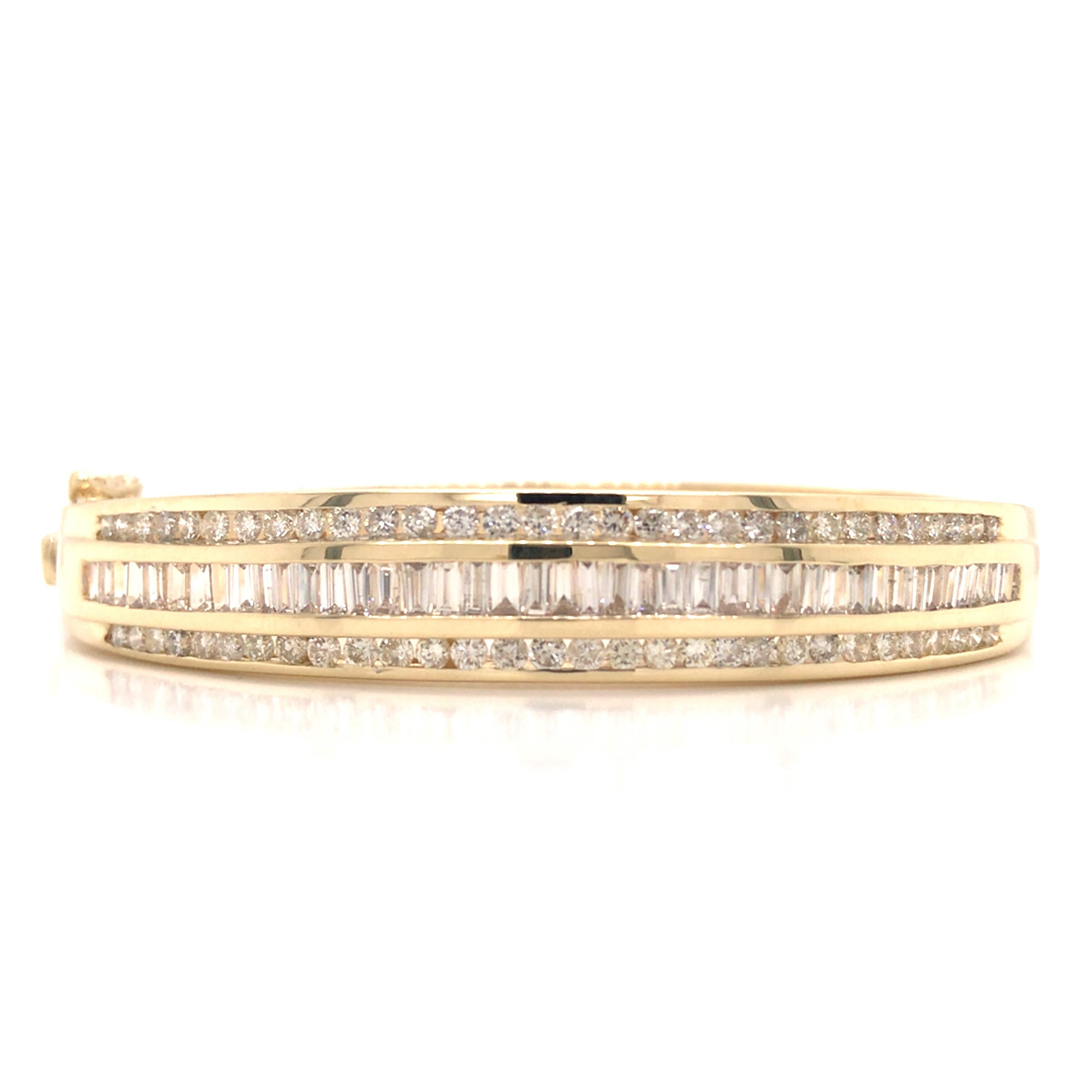 Round and Baguette Diamond Bangle Bracelet in 14K Yellow Gold.  Round Brilliant Cut and Baguette Diamonds weighing 5.0 carat total weight. G-I in color and VS-SI in clarity are expertly set.  The Bangle measures 6 3/4 inch inner circumference and