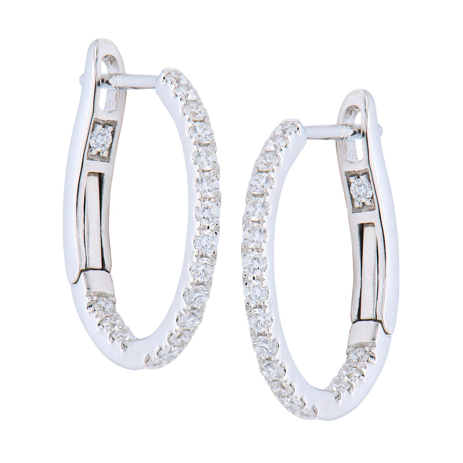 These classic huggies are made from 2.3 grams of 14 karat white gold. They contain 38 round G-H color SI1 diamonds totaling 0.31 carats. They are the perfect classic earrings that can be worn all the time and will never go out of style. 