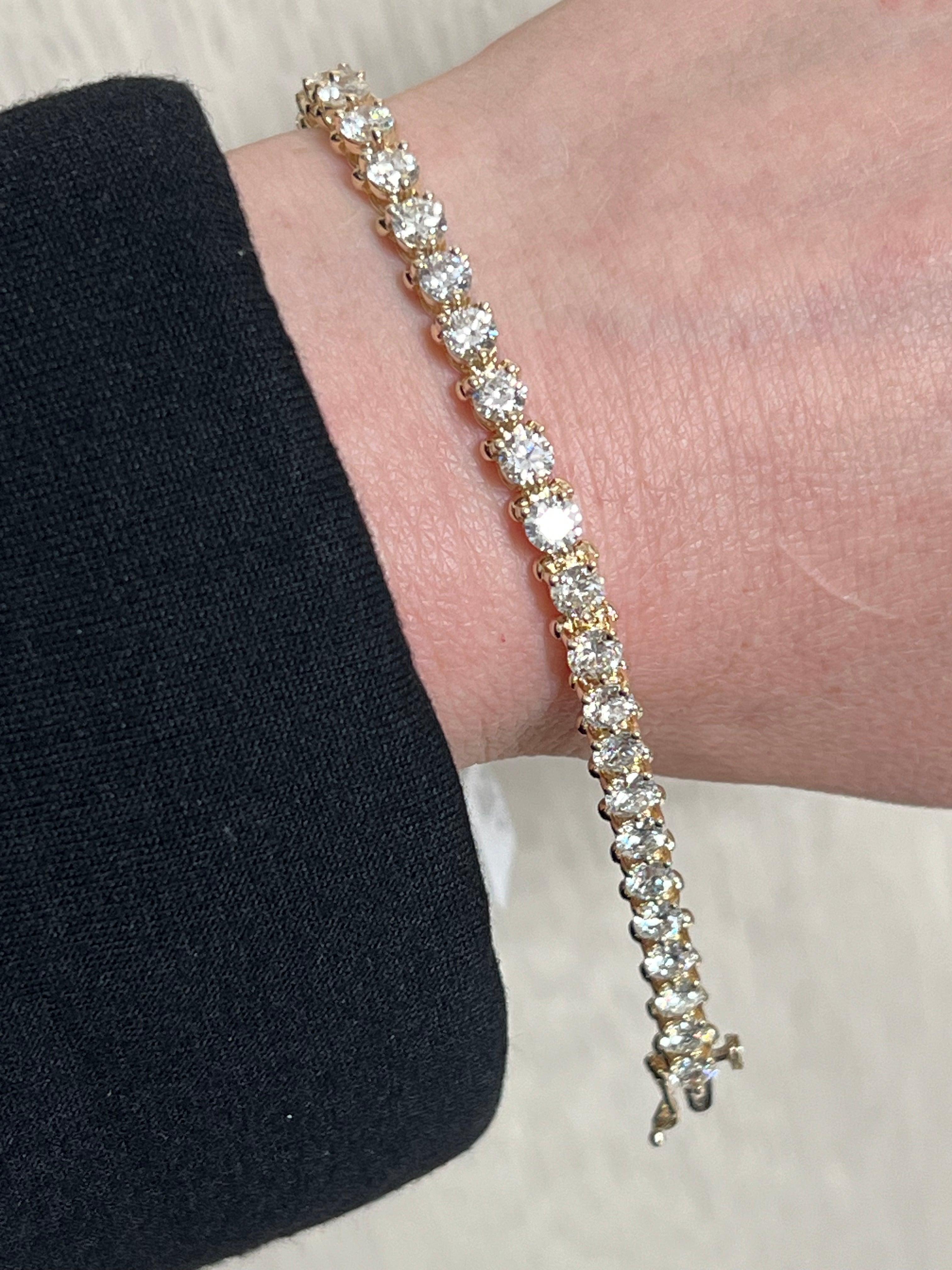Elevate your elegance with this stunning 14k Yellow Gold Round Diamond Tennis Bracelet. Perfect for any occasion, this timeless piece features 35 natural diamonds that shimmer with every movement. Meticulously crafted to showcase its beauty, the
