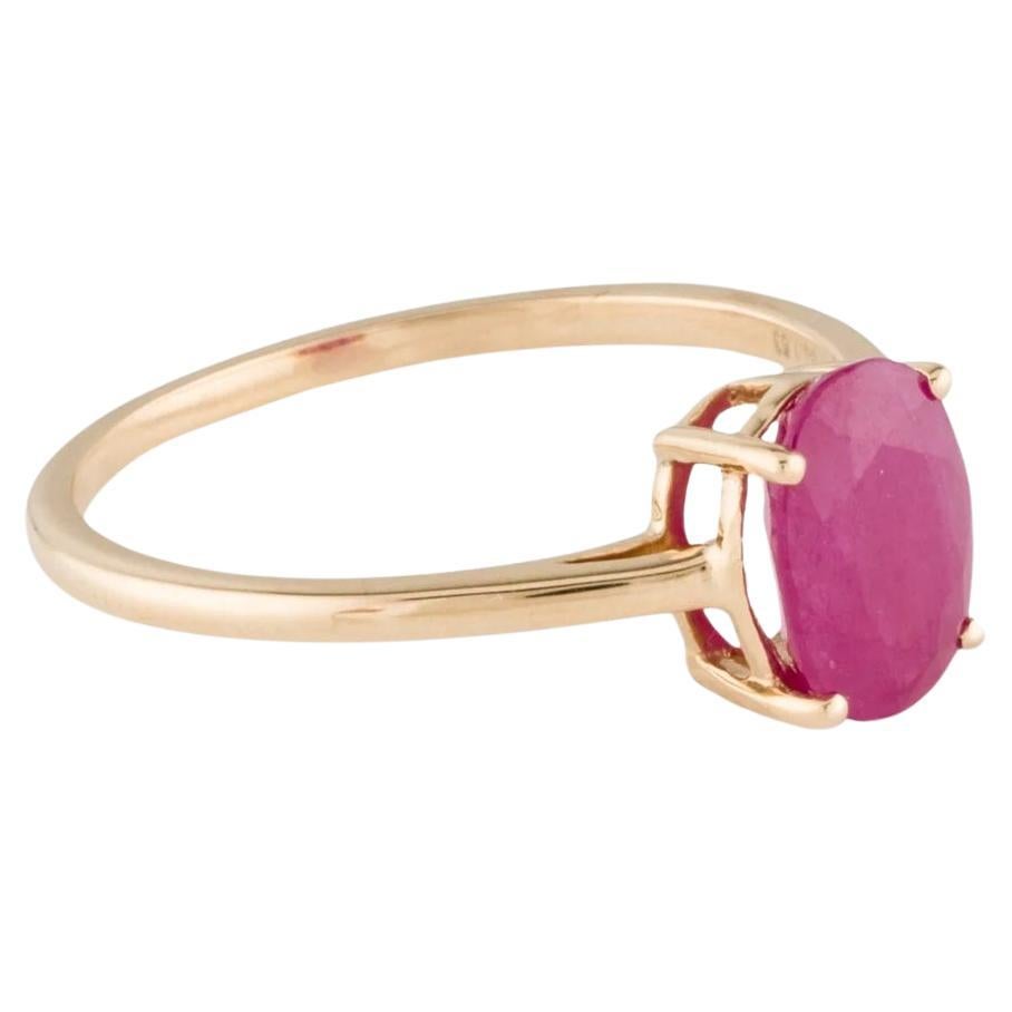 Enhance your elegance with this exquisite 14K Yellow Gold Ruby Cocktail Ring. Crafted with precision and attention to detail, this ring features a stunning 1.41 Carat Oval Modified Brilliant Ruby as the centerpiece. The rich red hue of the ruby,