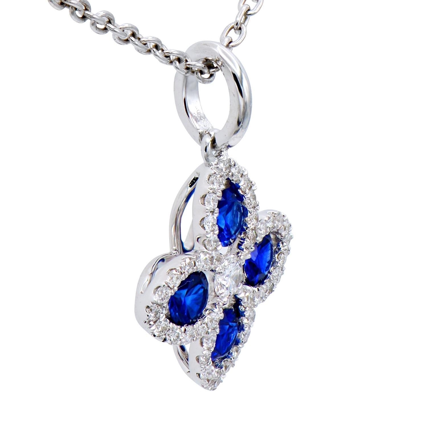 This beautiful pendant is made from 4 sapphires totaling 0.37 carats which are surrounded by 41 round VS2, G color diamonds totaling 0.14 carats. Together they form a lovely flower or four-leaf shape that is classic and timeless. The pendant is made