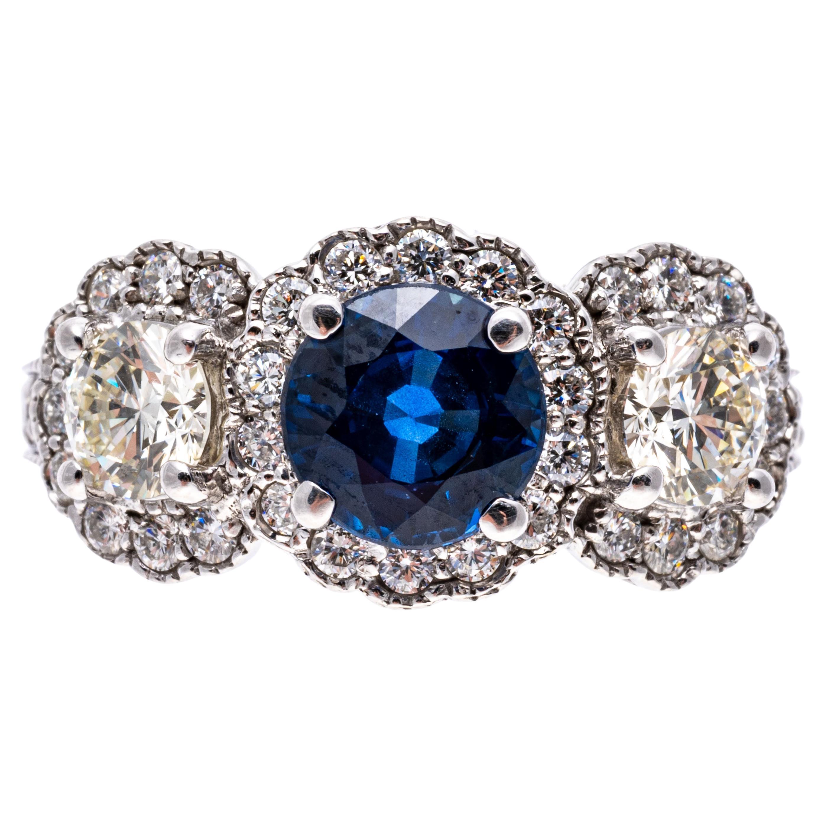 14k White Gold Blue Sapphire and Diamond Halo Three Stone Ring, App. 0.57 TCW For Sale