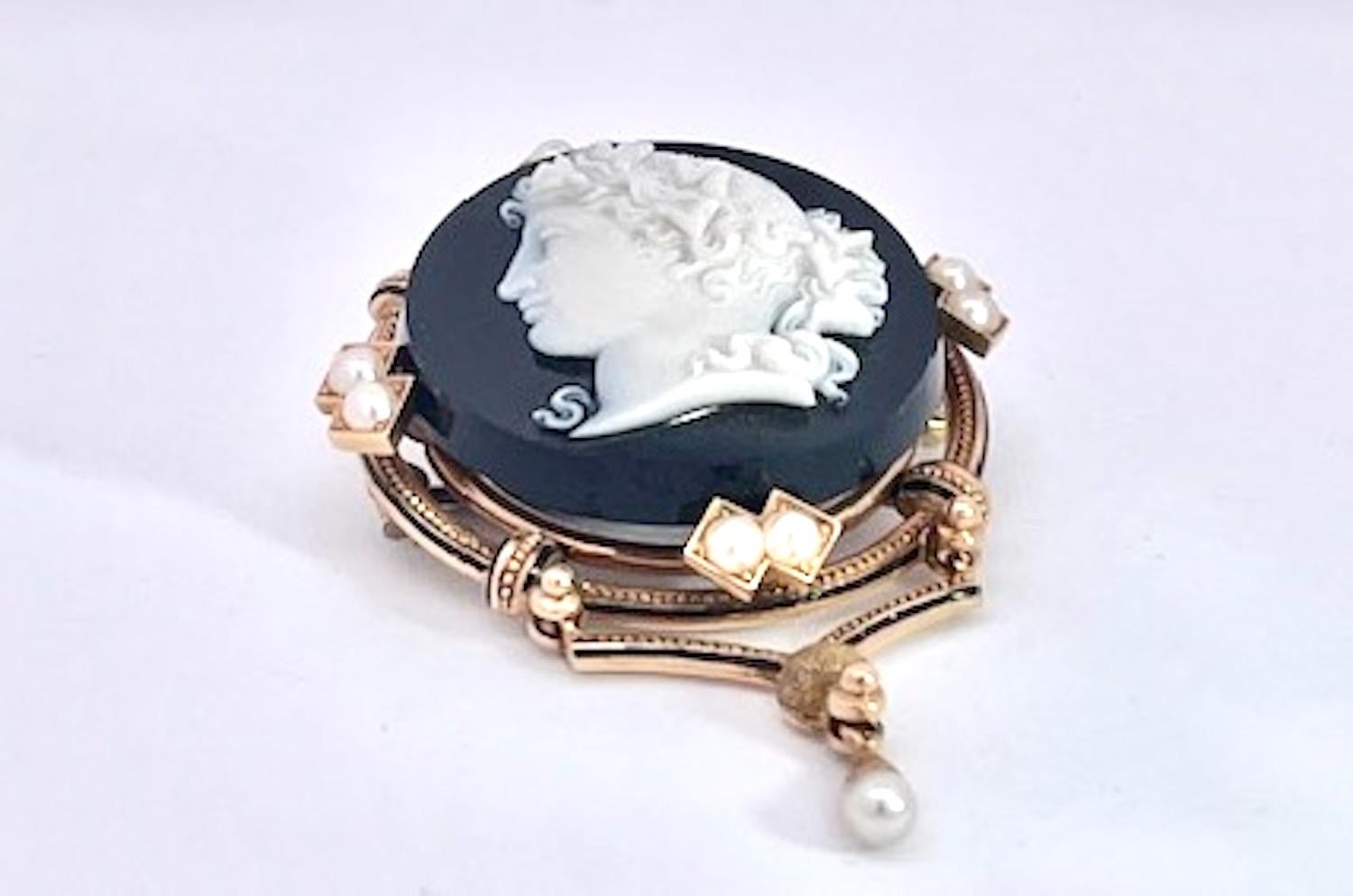 This brooch and earrings are special and in perfect condition.  The brooch has a female portrait carved in a beautiful detailed manner.  There are 9 pearls surrounding the Cameo with a split pearl drop.  This measures 5 mm long 3 mm wide and 1 1/2