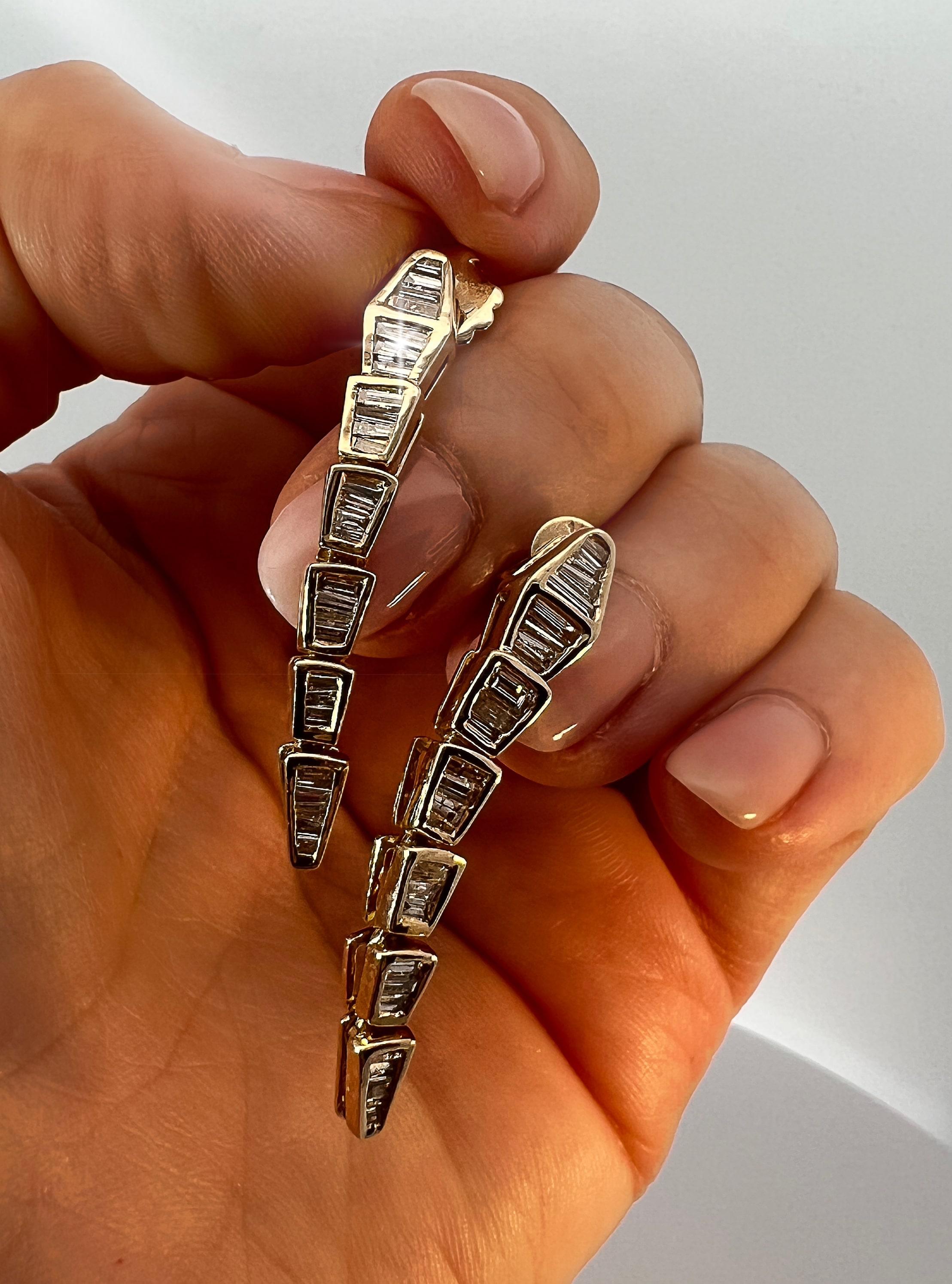 A captivating fusion of elegance and edge, it's a statement piece designed for those who dare to stand out.

Earring Information
Metal: 14K Gold
Color: Yellow Gold
Total Diamond Carats: 1.13ct
Diamond Cut: Baguette
Diamond Color: G/H
Diamond