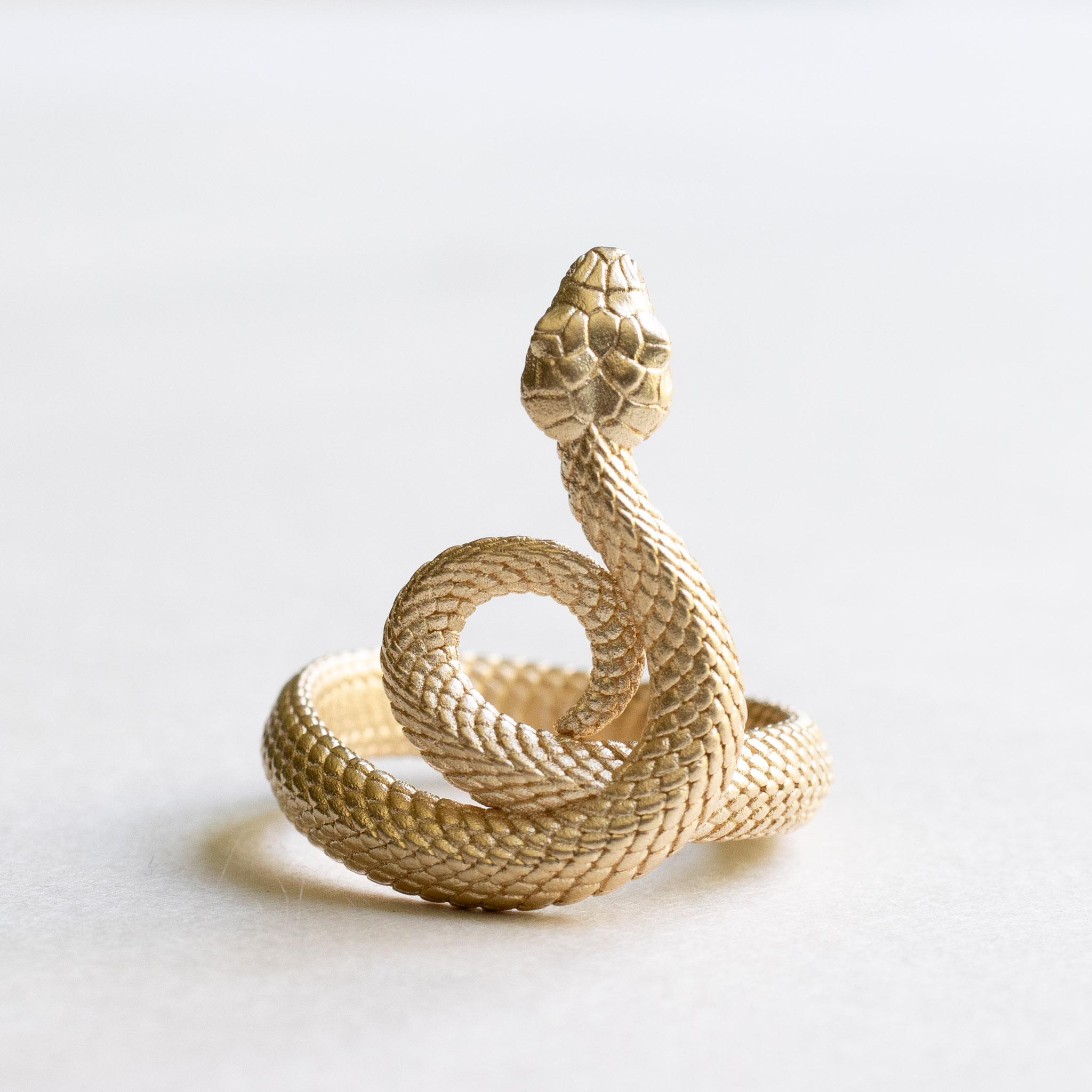 A wrap around sculpture snake with intricate detailing inside and out. 

Metal: 14k yellow gold
Approx 4mm band width
Available in rose, yellow or white gold. 