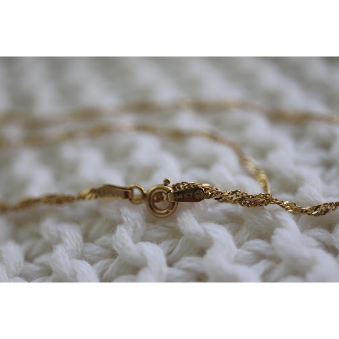 Vintage from the 1990s
Materials: Gold
Closure: Lobster claw
Chain style: Rope

Necklace length: 24 Inches

14k Singapore Chain Necklace Extra Long.

24inches
4mm wide
3.2grams

Estate necklace. No visible wear or tear.
