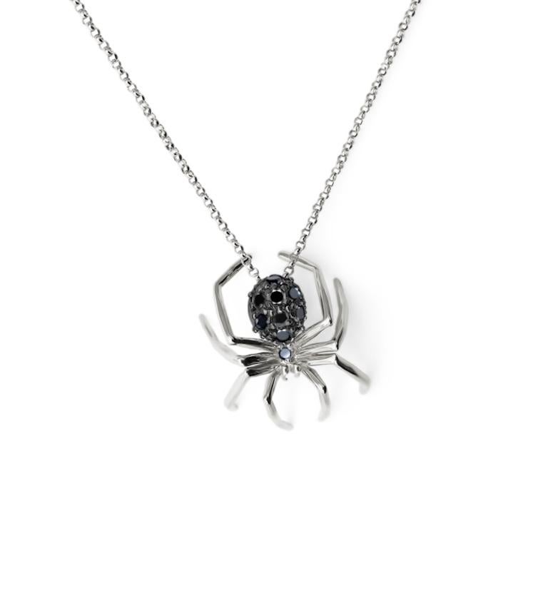 Prepare to embrace the captivating allure of darkness with the Small Spider Pendant in 14k White Gold and Black Rhodium. This mesmerizing piece is a true embodiment of mystique and sophistication, designed to ignite a sense of intrigue and