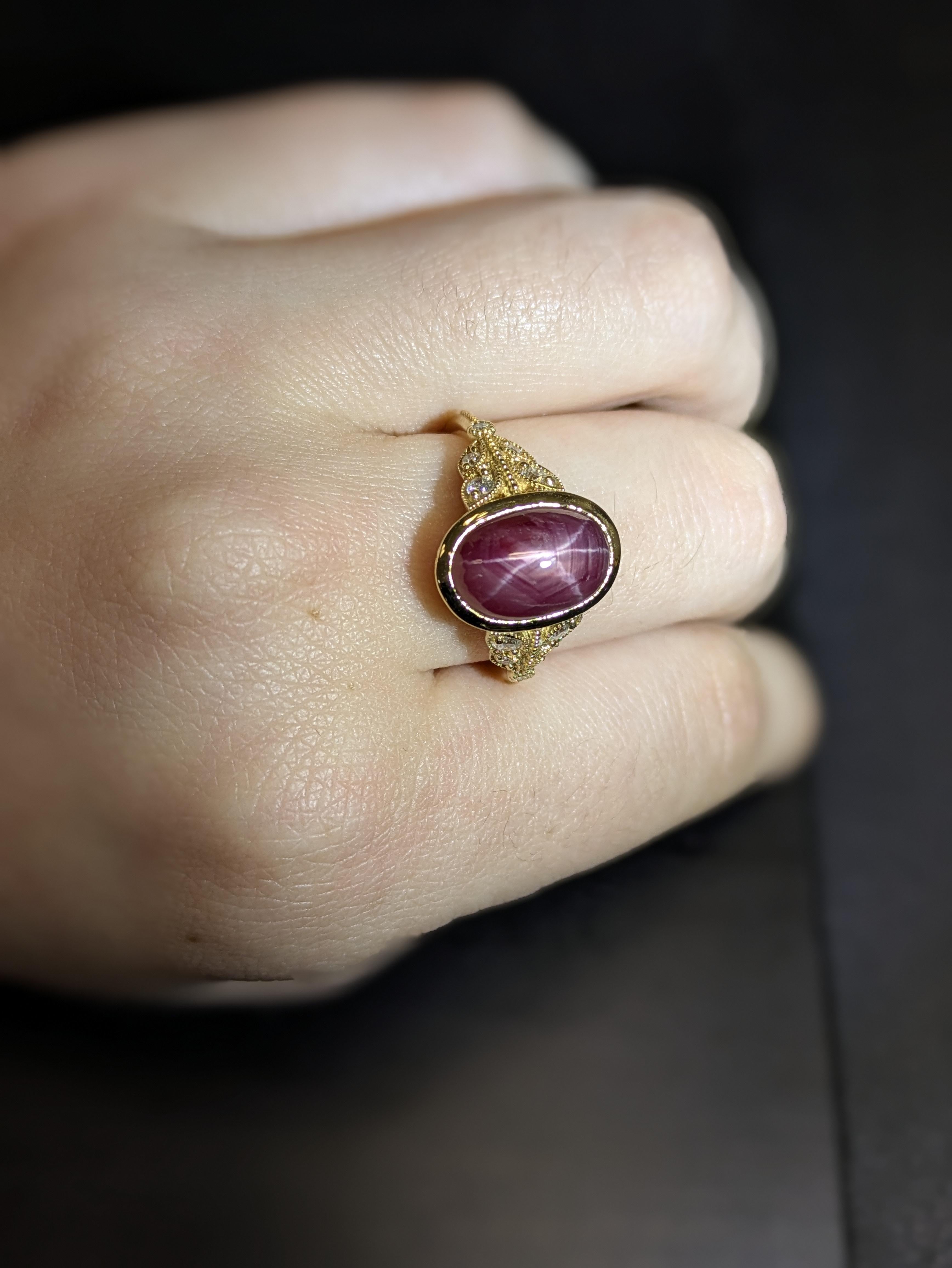 Dieser Ring im Vintage-Stil präsentiert einen faszinierenden ovalen Sternrubin von 6,78 Karat in einer eleganten Lünettenfassung, umrahmt von funkelnden Diamanten aus Erdmineralien. Der aus massivem 14-karätigem Gelbgold gefertigte Anhänger ist das