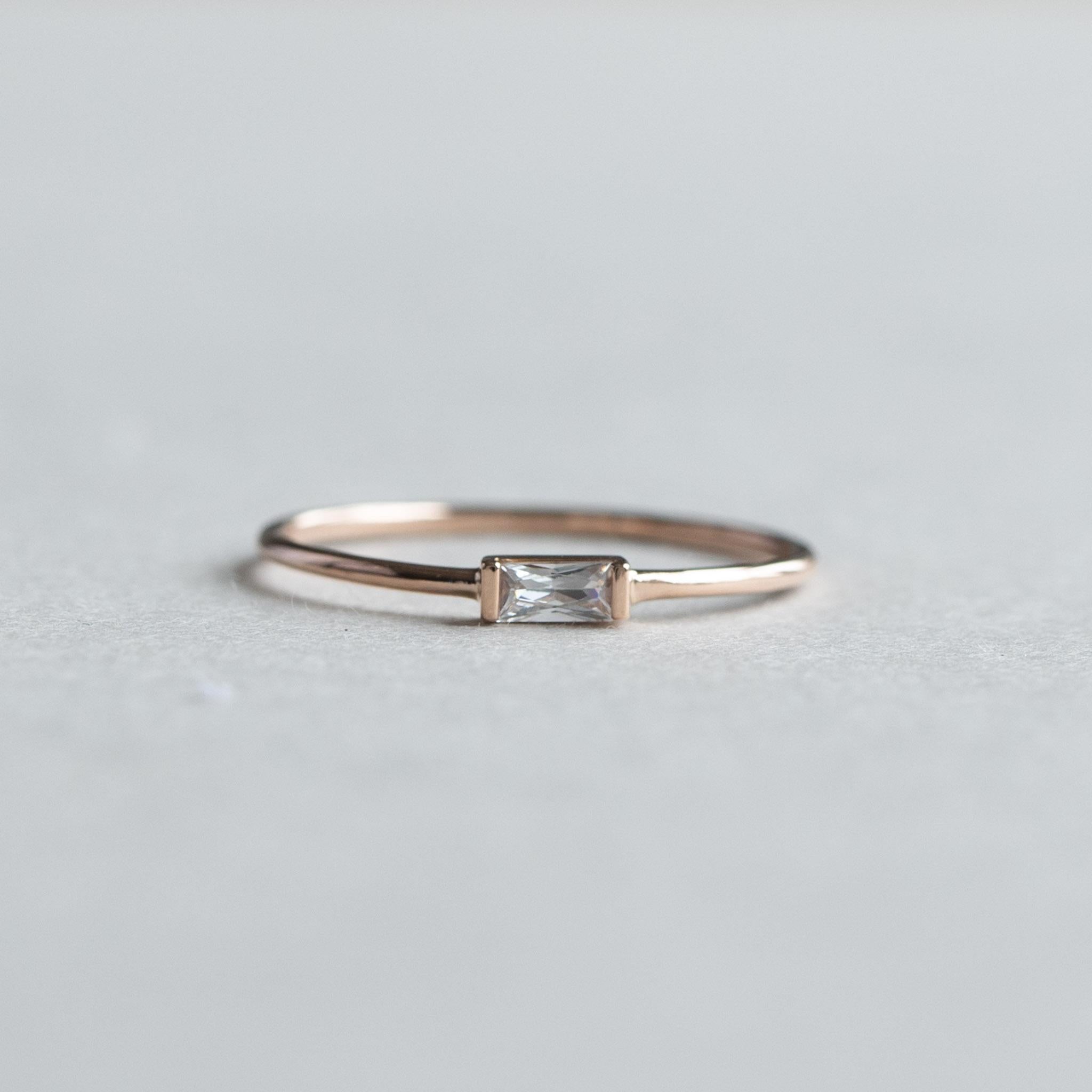 East west baguette accents this slim whisper thin ring.
14k solid gold or rose gold available
Cubic Zirconia stone set on half bezel setting
14k hallmarked
Stone Size: 2mmx5mm
1 mm band width.

Size 7 ready to ship 
