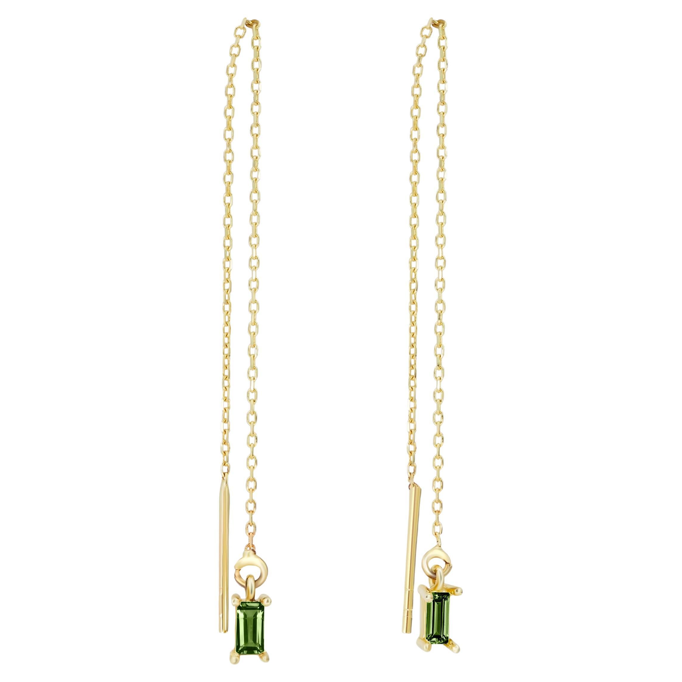 14k solid gold drop earrings with peridots. 