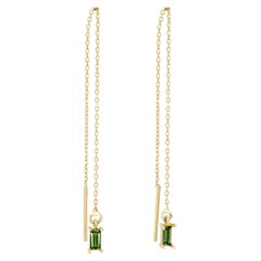 14k solid gold drop earrings with peridots. 