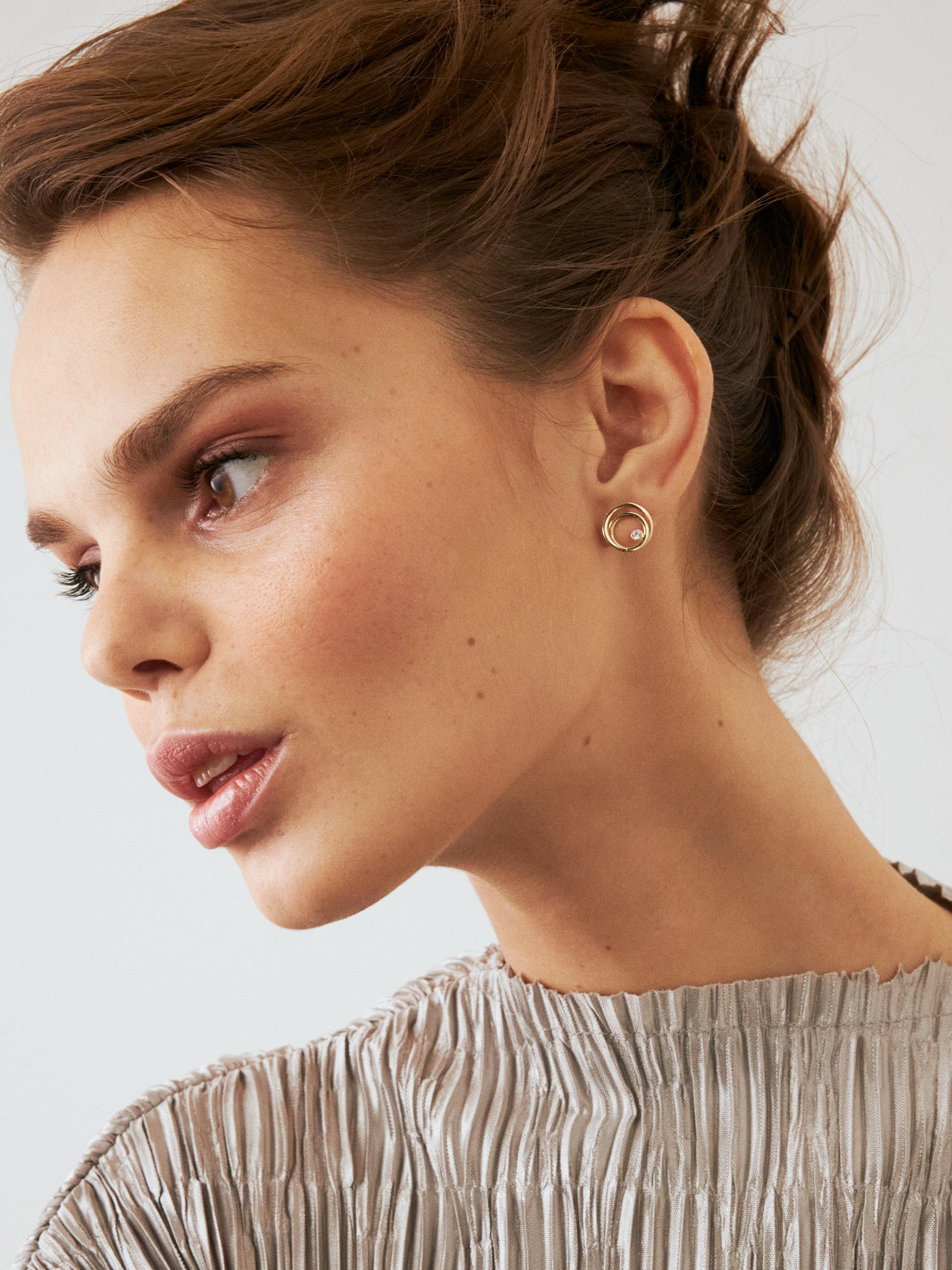 Introducing the 14K Gold Diamond Circle Earrings, a symbol of Orena Jewelry's unwavering devotion to unmatched artistry. Each earring is delicately handcrafted, offering a blend of opulence seamlessly meshed with enduring style, making it an